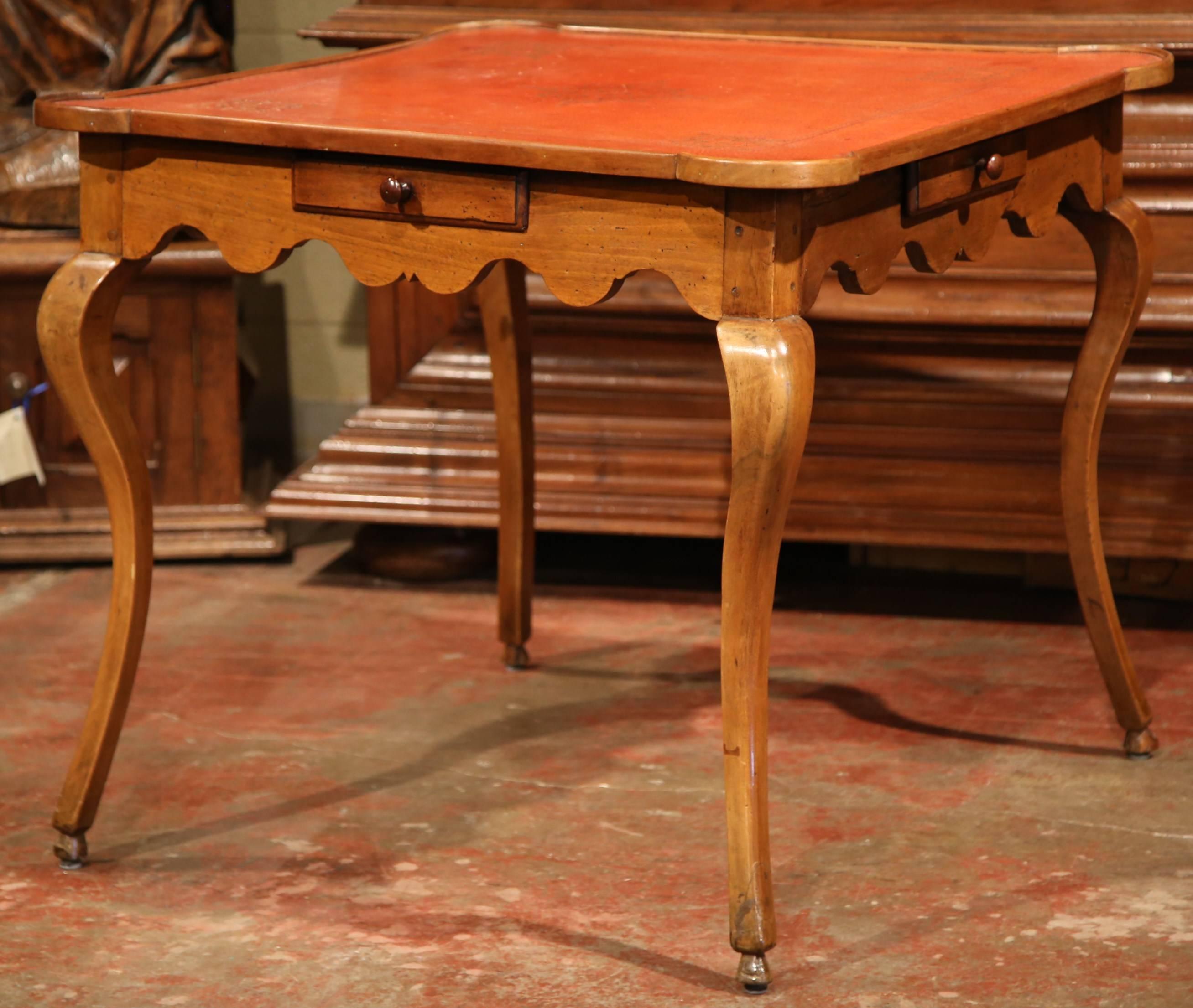 Have your next poker or bridge tournament around this elegant square fruit wood table. Crafted in France, circa 1850, the antique game table has rounded corners, a shaped apron and four cabriole legs with hoof feet. The table has a small drawer on