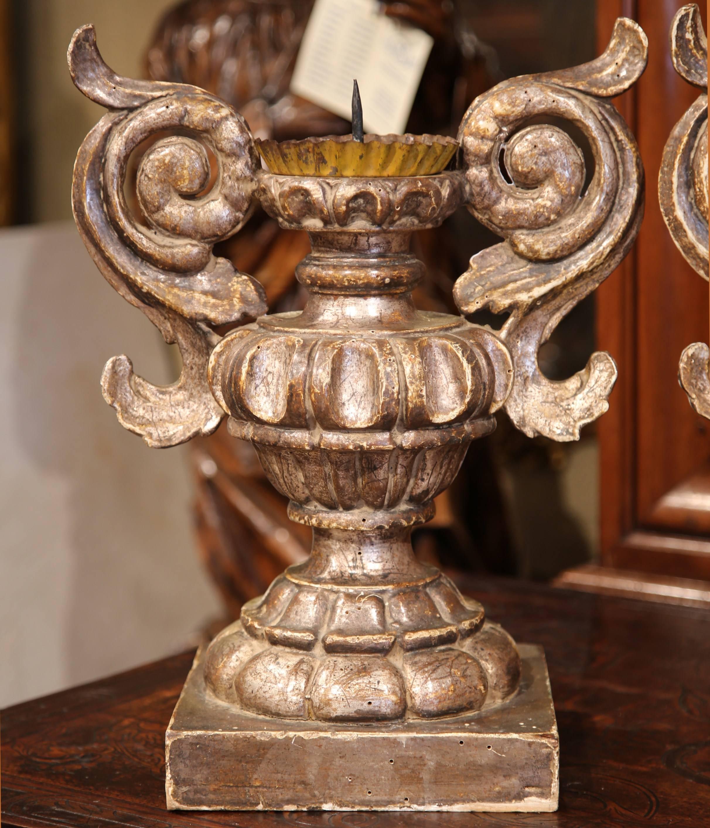 Embellish your mantel or a countertop with this elegant pair of antique, hand-carved candleholders. Crafted in Italy, circa 1870, these ornate candlesticks are shaped as Classical Roman vases with square bases. The unique pieces have two curved