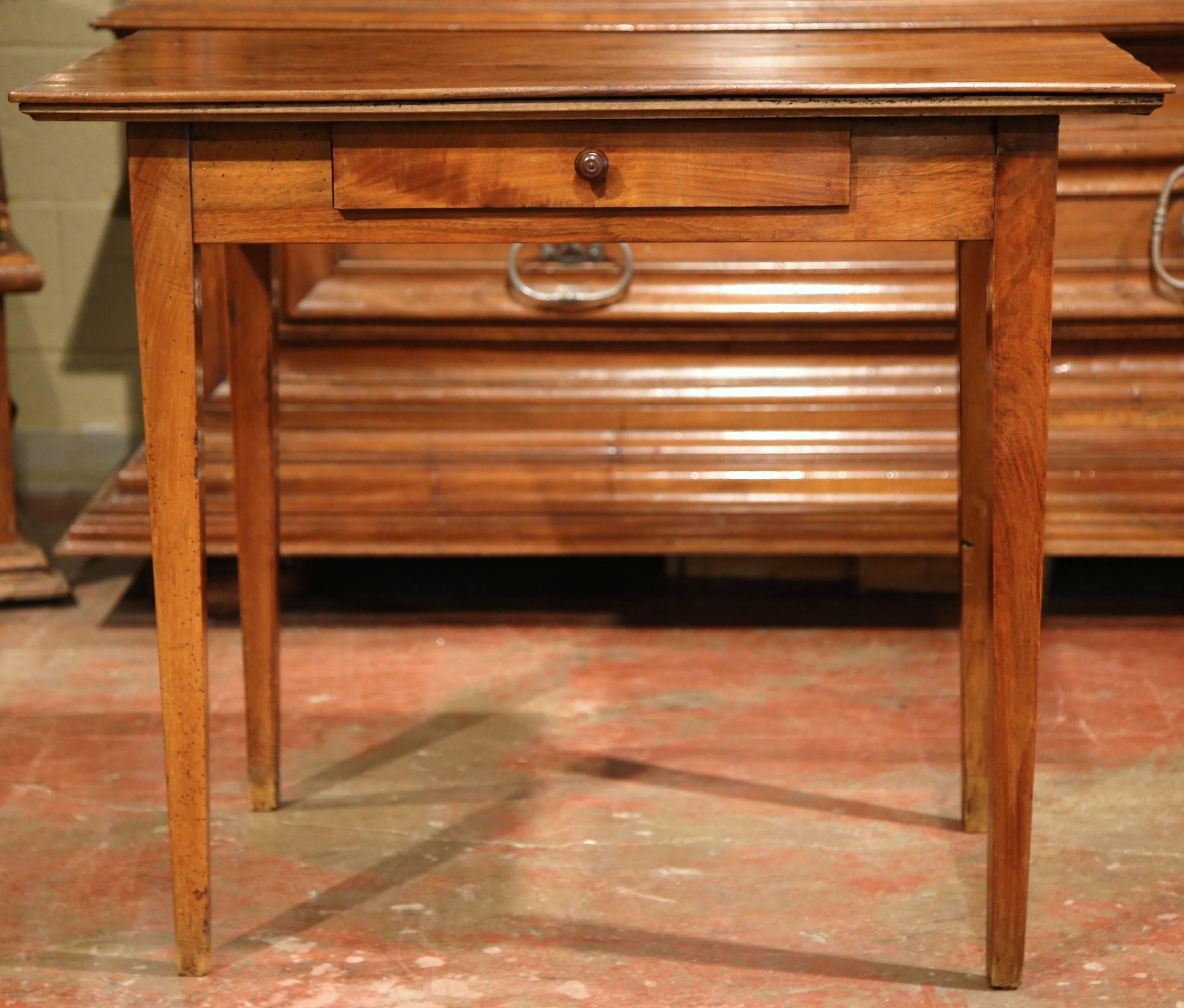 This versatile, antique fruitwood end table was carved in the Poitou region of France, circa 1880. The small desk has a drawer across the front with four slim, tapered legs. This piece can be used as a desk or as a side table next to a bed. The