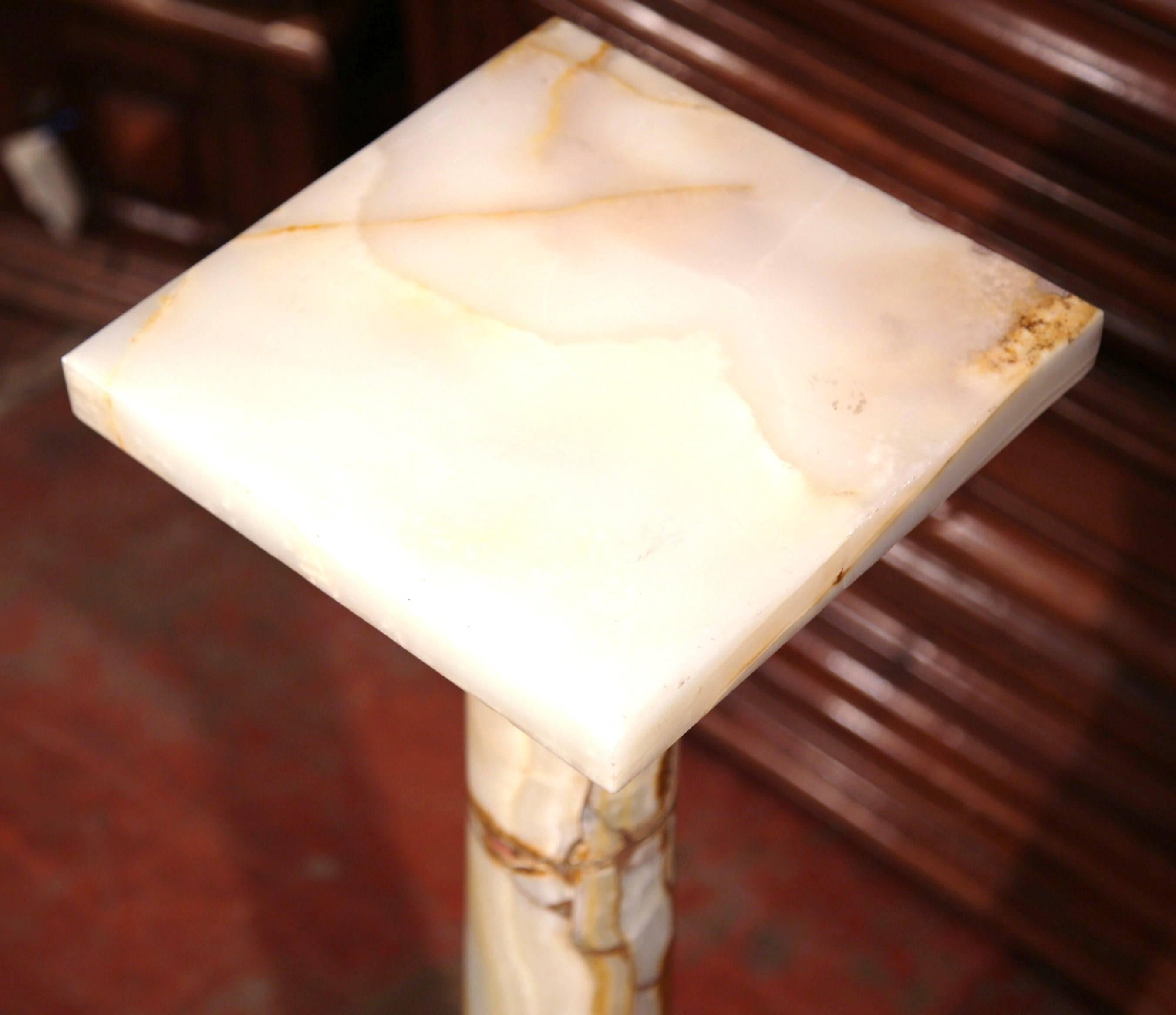 Display a figural bust or a flower vase in a formal living room or dining room on this fine antique pedestal. Crafted in France, circa 1860, this Classic, tall pedestal is a work of art itself. The white onyx base has a square swivel top with ornate