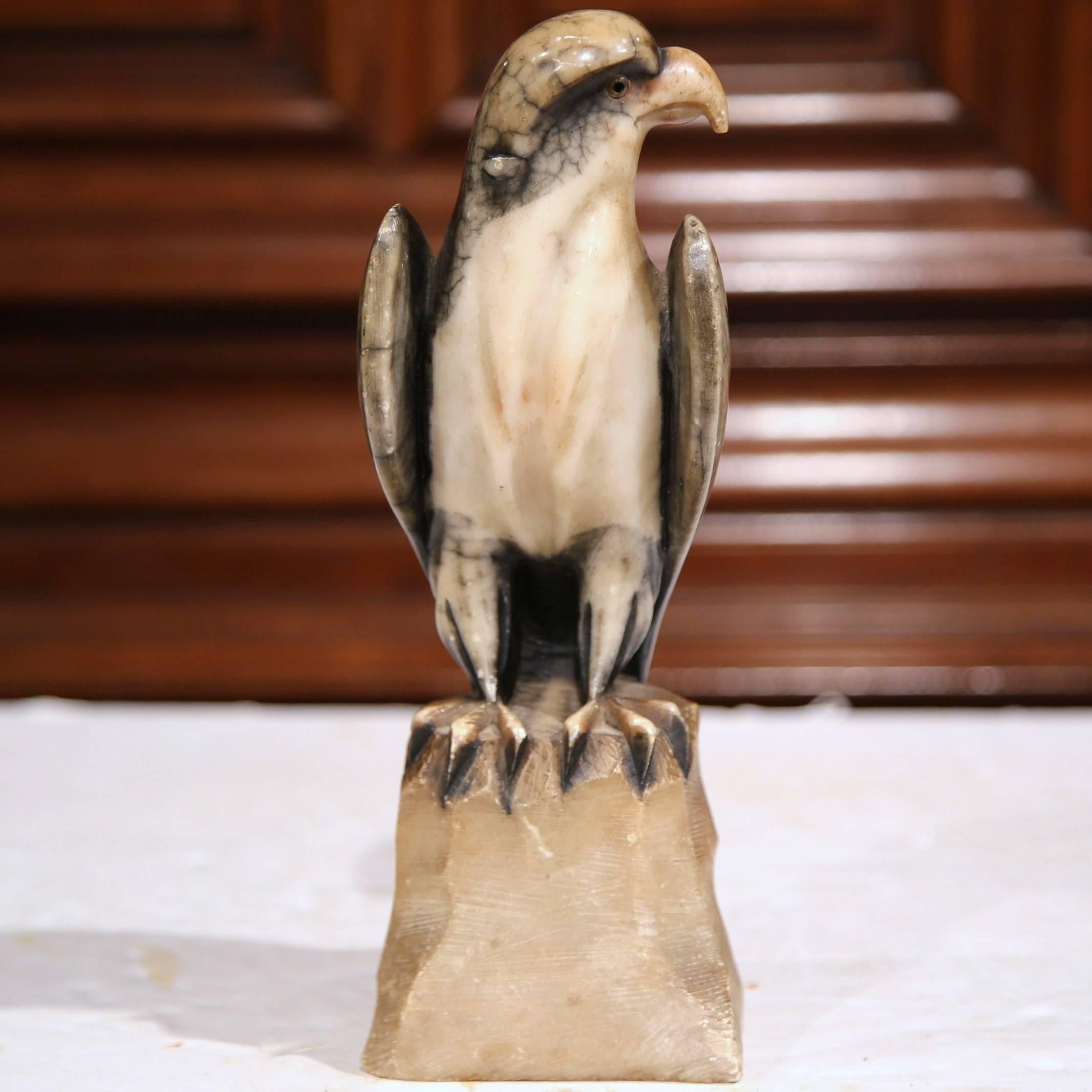 This fine, carved, antique marble eagle was created in France, circa 1860. The gray and white bird sits on a rock with his head turned. Use the avian figure to decorate a mantel, library or study. The sculpture is in great condition with a beautiful