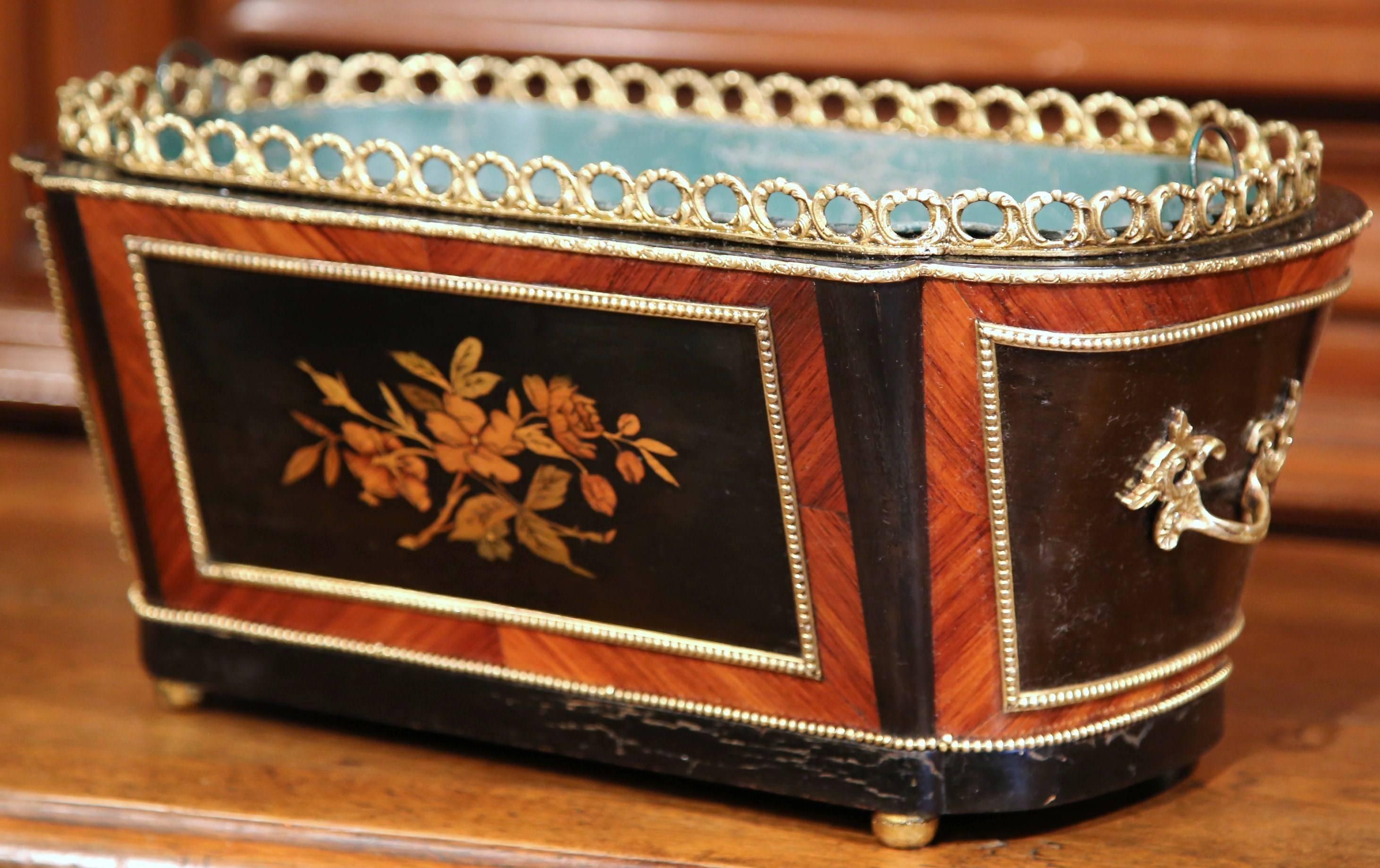 This elegant oval fruitwood planter was crafted in Paris, France, circa 1870. The antique, rosewood and ebony jardinière sits on four round feet; it features intricate marquetry and parquetry decor including colorful inlay floral and leaf motifs on