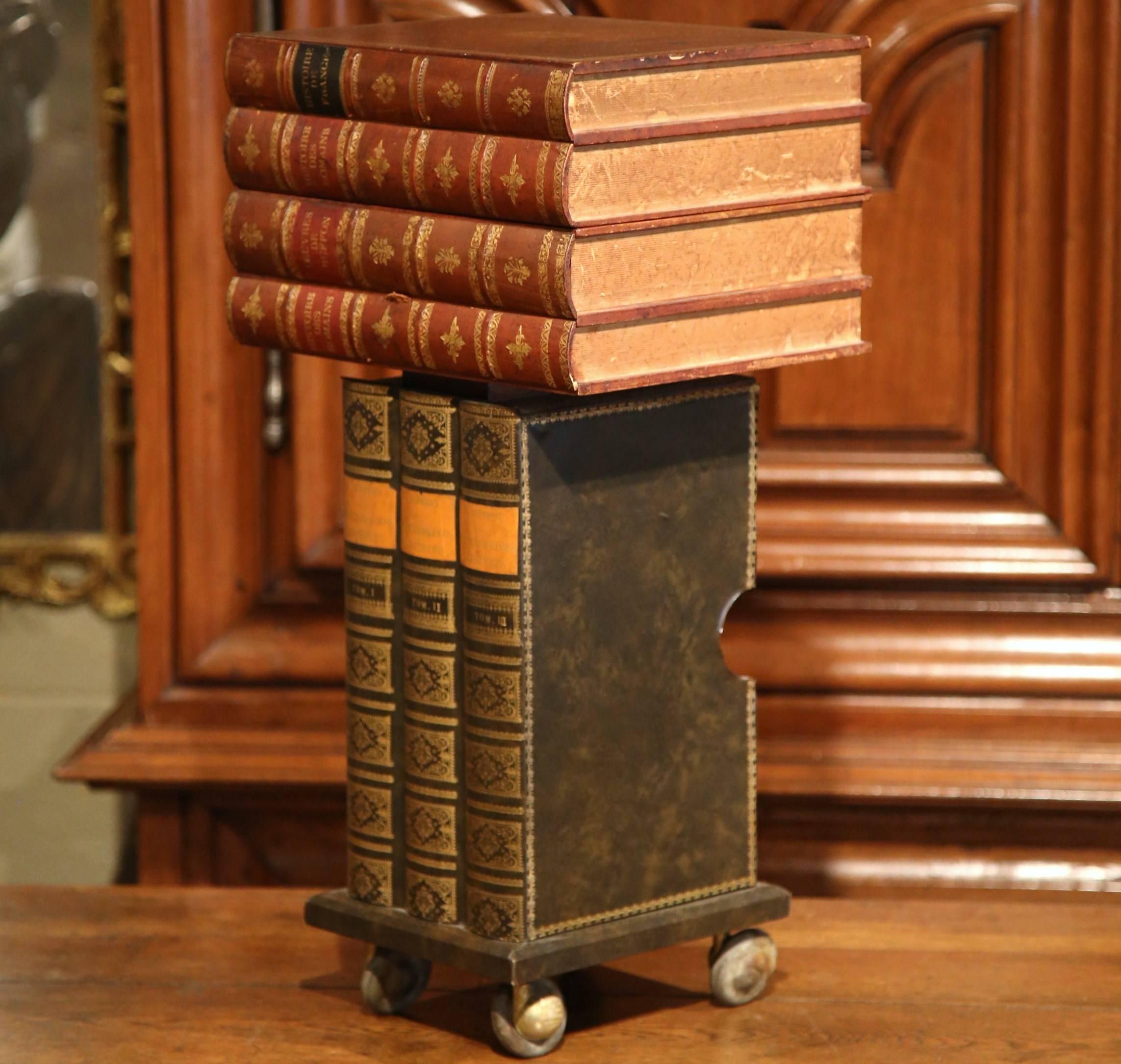 Start a conversation with this interesting, vintage side table. Crafted in France circa 1960, this small table on wheels resembles a stack of antique books. The functional, mobile storage solution has seven lookalike books, a drawer and an open top