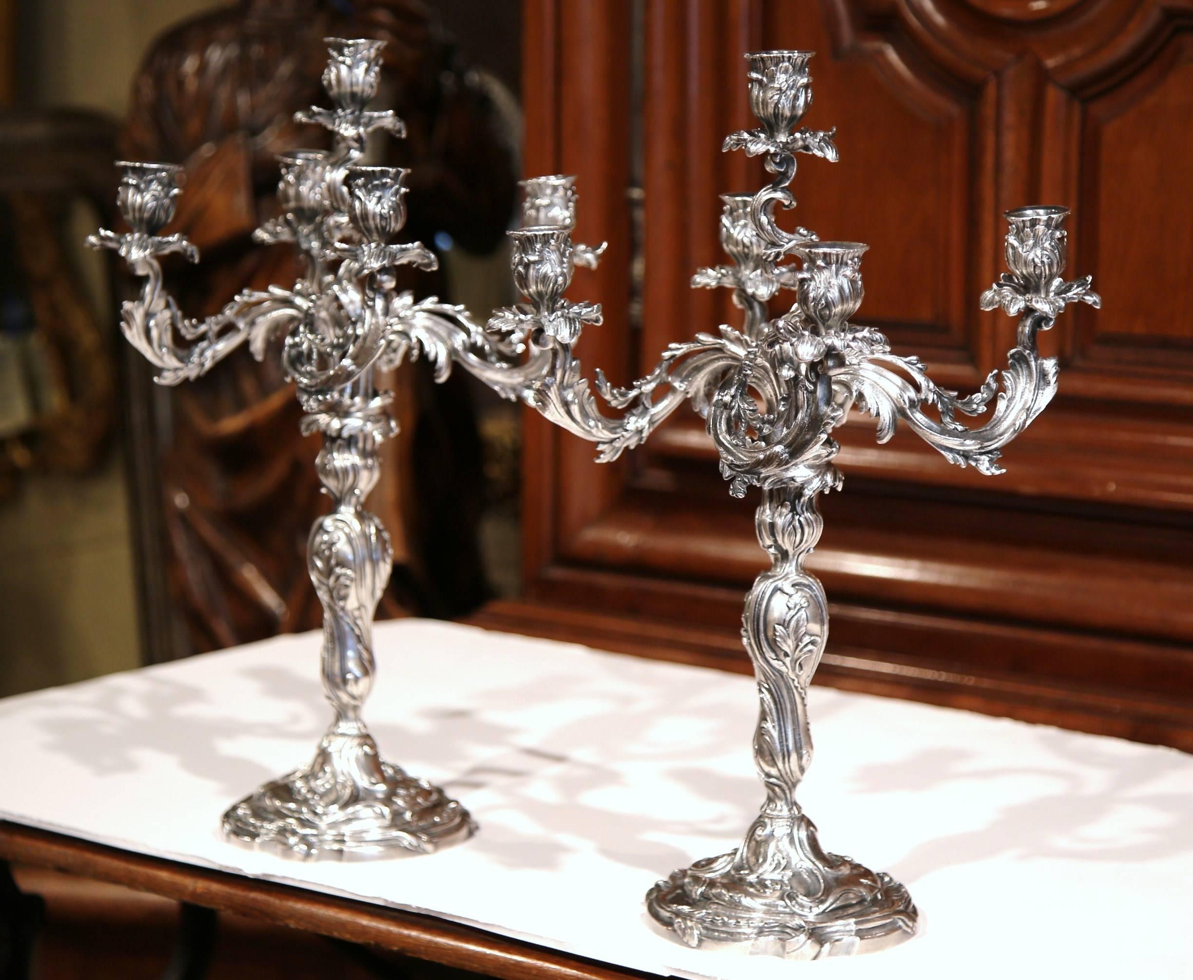 Decorate a dining table or console with this elegant pair of antique bronze candleholders from Paris, France. Crafted circa 1860, each candelabra features five beautiful, scrolled arms with leaves that have been silvered. The ornate candlesticks are
