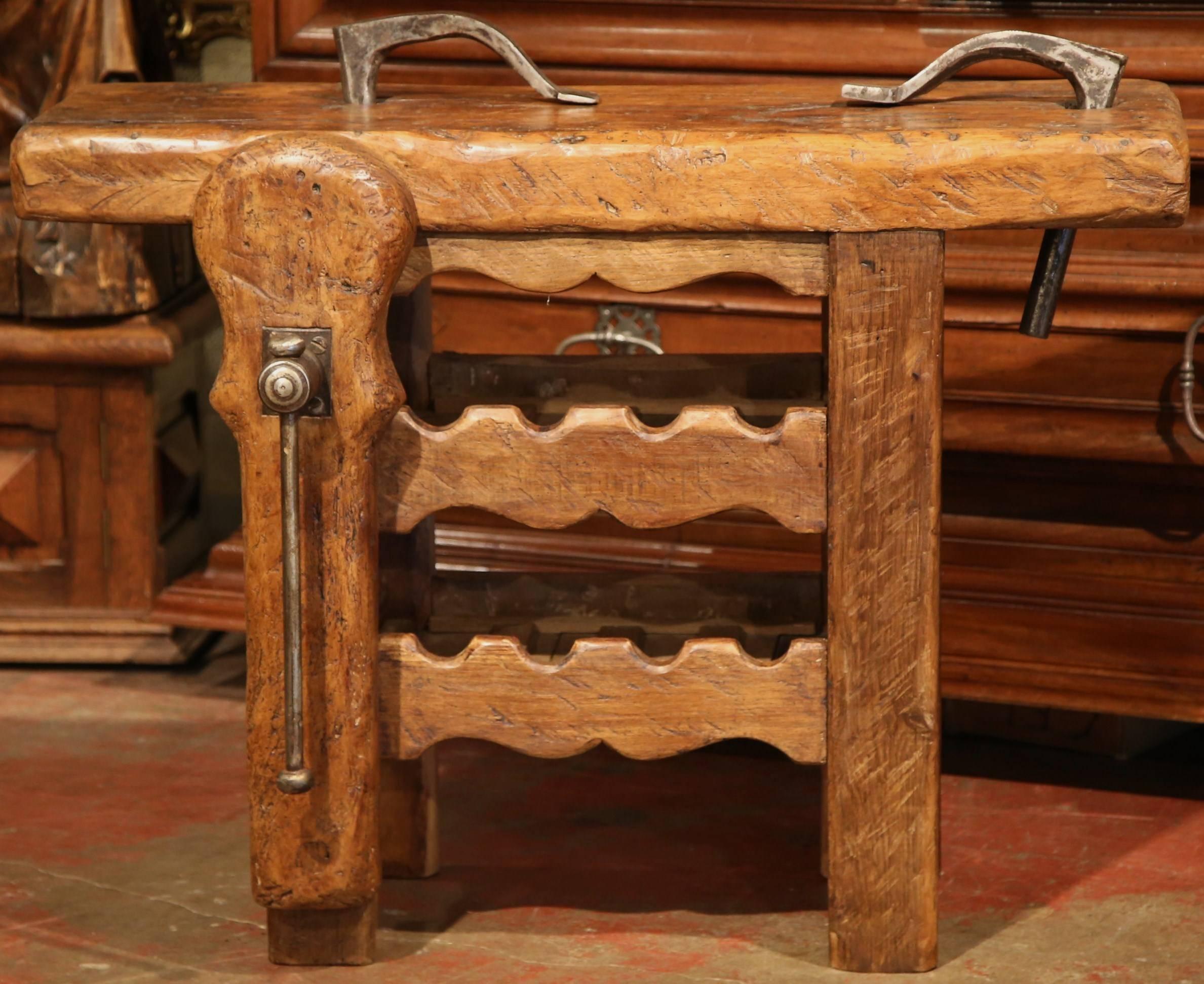 This antique table was crafted in the Poitou region of France, circa 1880. The rustic, oak piece has a very thick top and features two rows underneath specifically for the storage of eight wine bottles. This sturdy, Provincial table is in excellent