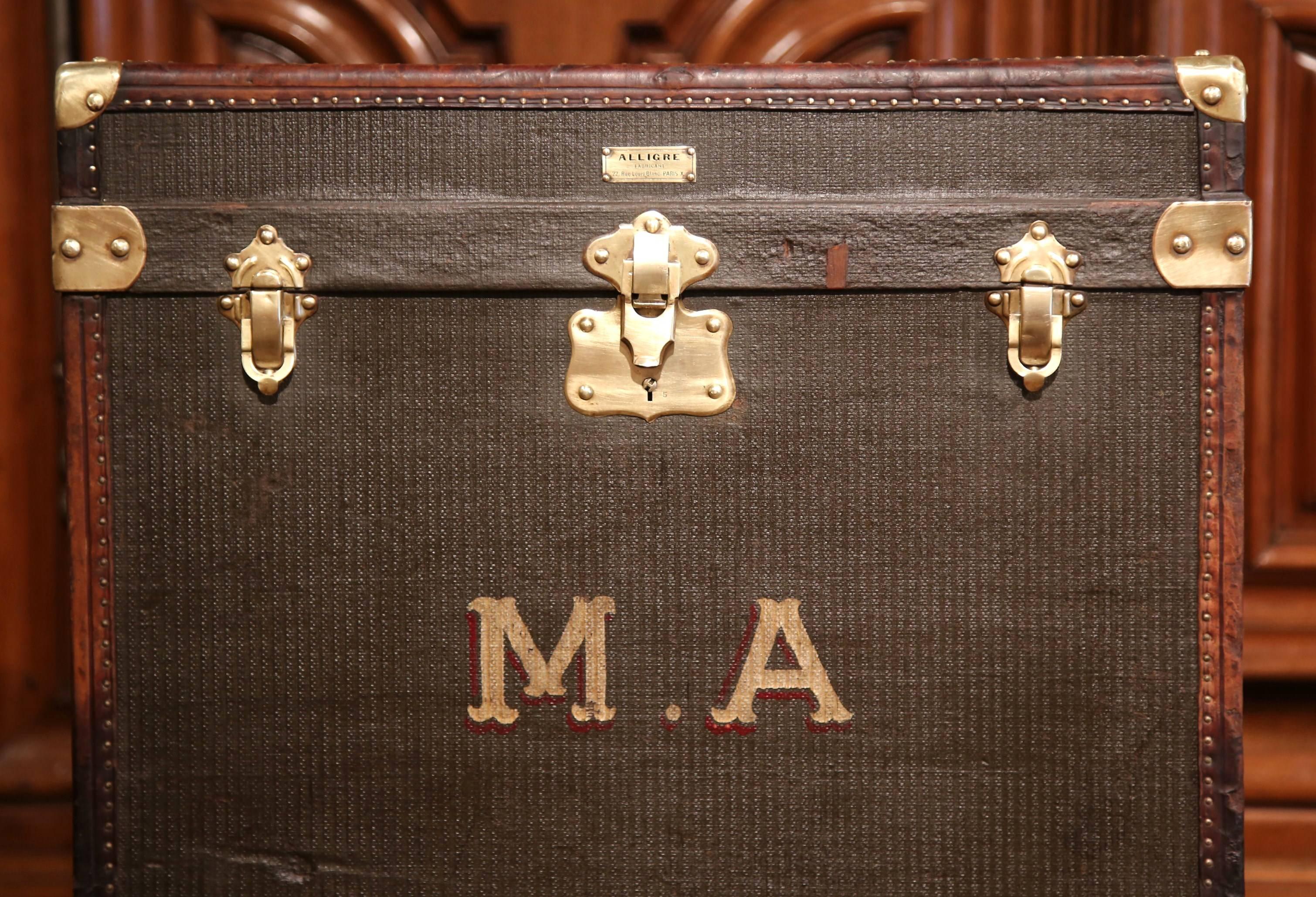 Almost square in shape, this leather trunk was crafted in Paris, France, circa 1860. The piece features brass mounts on the corners with the initials MA. The inside has been reupholstered with new fabric and two bags of fresh lavender. The trunk,