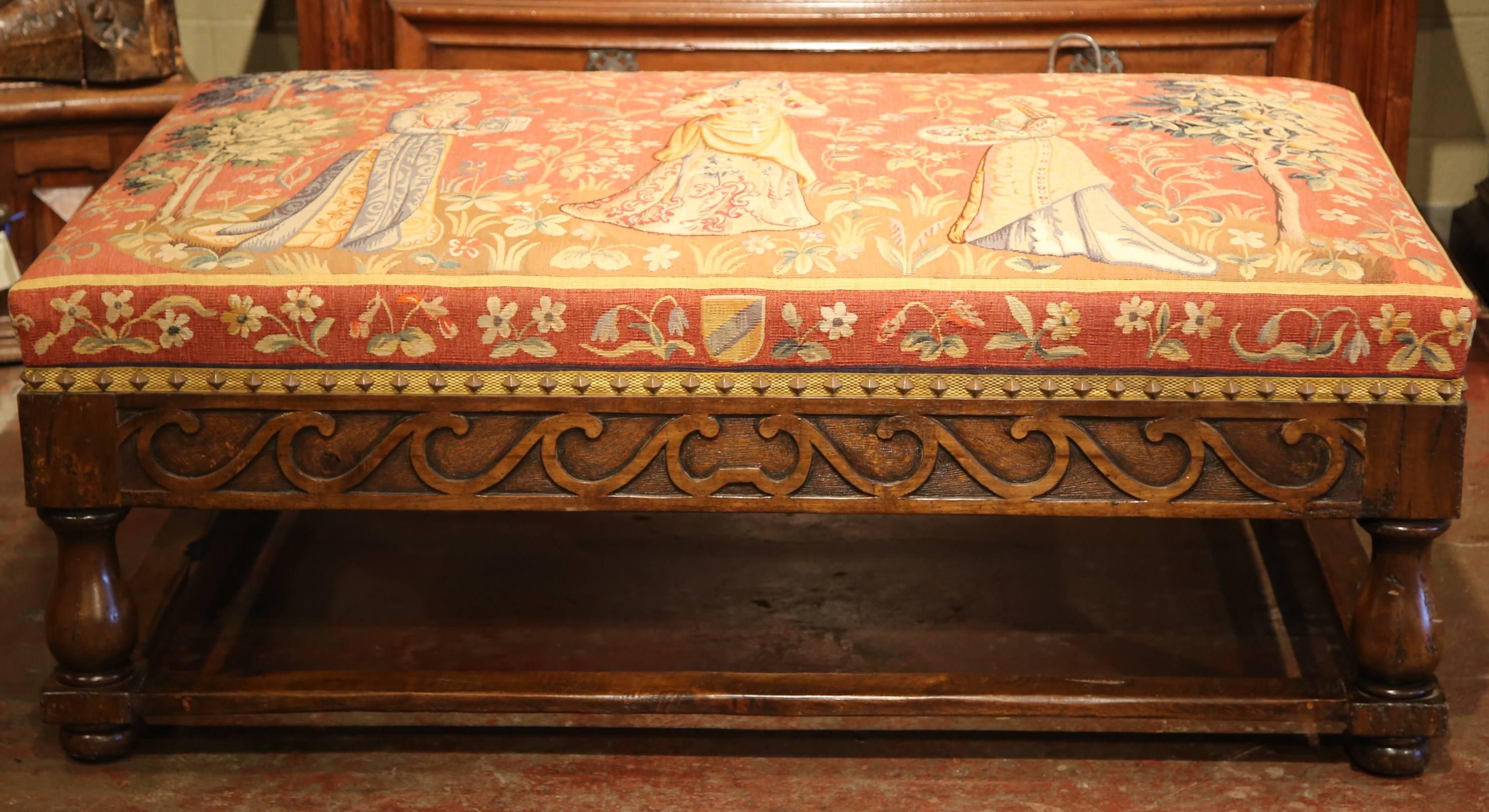 Add colors and elegance to your den with this beautifully carved fruit wood coffee table or ottoman; crafted in France and upholstered with 19th century Aubusson in the manner of Cluny, the antique colorful tapestry, features three women in long