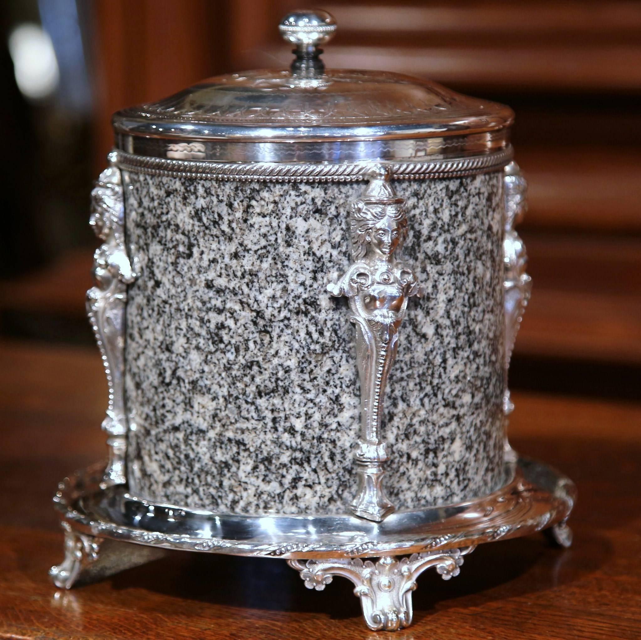 This elegant, antique biscuit box was crafted by Roberts & Bell, in Sheffield, England, circa 1864-1920. Cylindrical in form, the granite body of the container is topped with a silver plated, hinged cover finely chased, four scrolled feet at the