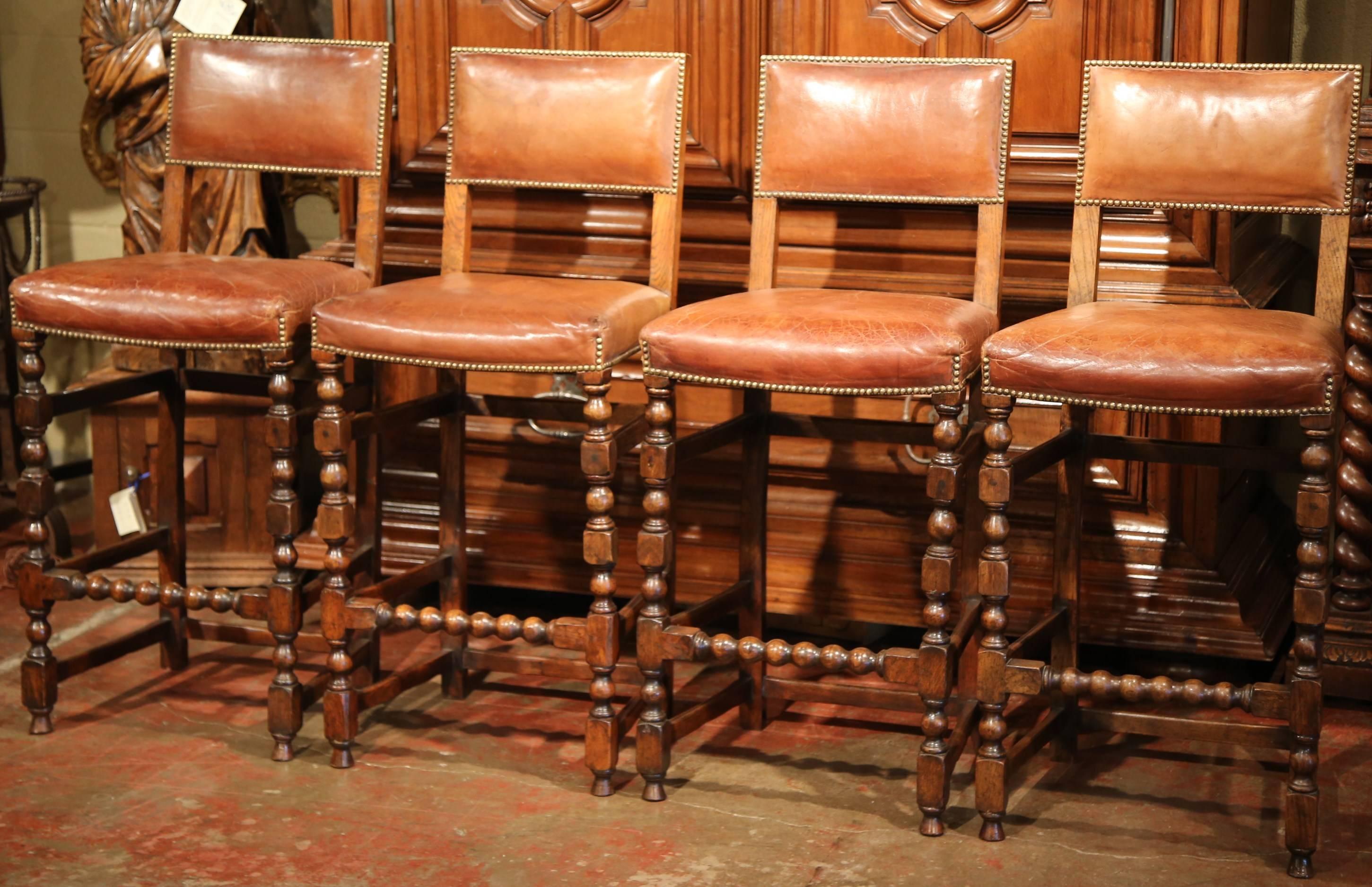 Add a Gothic look to your bar or counter with this elegant set of four antique stools. Crafted in France circa 1870, the high chairs are the perfect height for a 42 to 45
