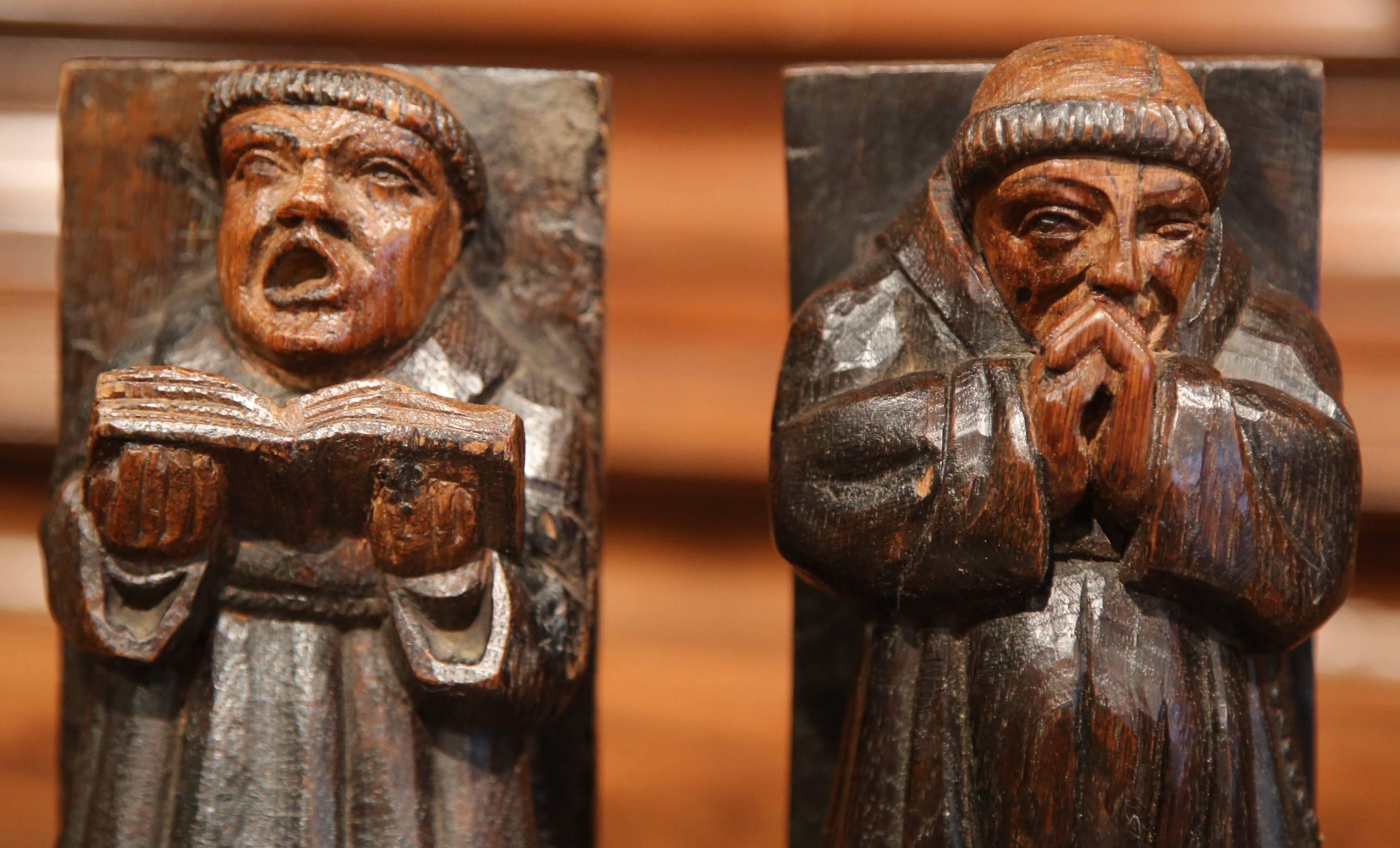 This fun pair of antique, wooden bookends were crafted in Spain, circa 1780. The library essentials are carved of solid oak and each feature a stylized monk figure. One monk is singing and holding a music book, the other is praying. Both pieces are