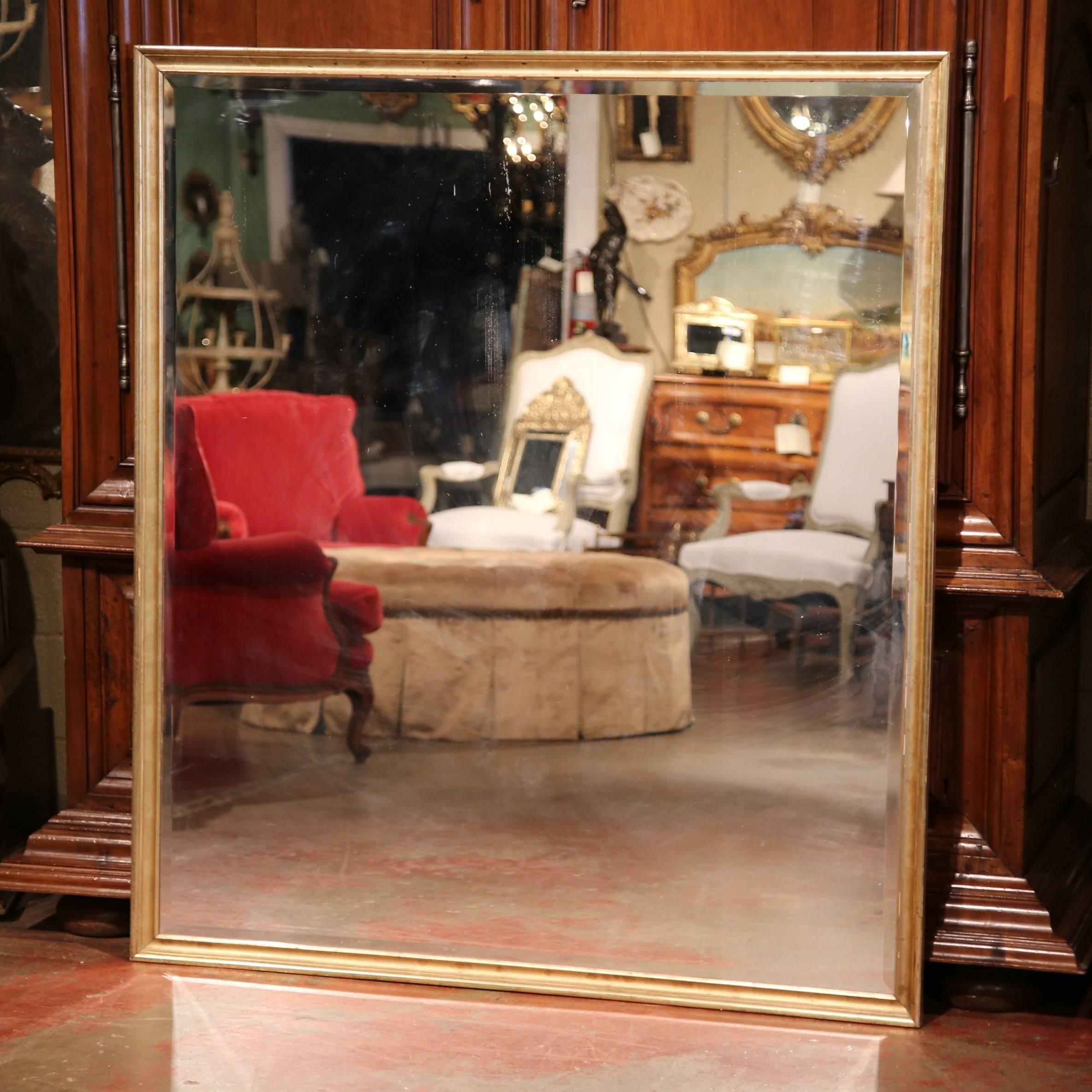 This elegant, antique wall mirror was crafted in France, circa 1870. The large, square, wooden frame is embellished with gold leaf, and can be hung either vertically or horizontally. The Louis XVI Classic frame features a new beveled glass mirror