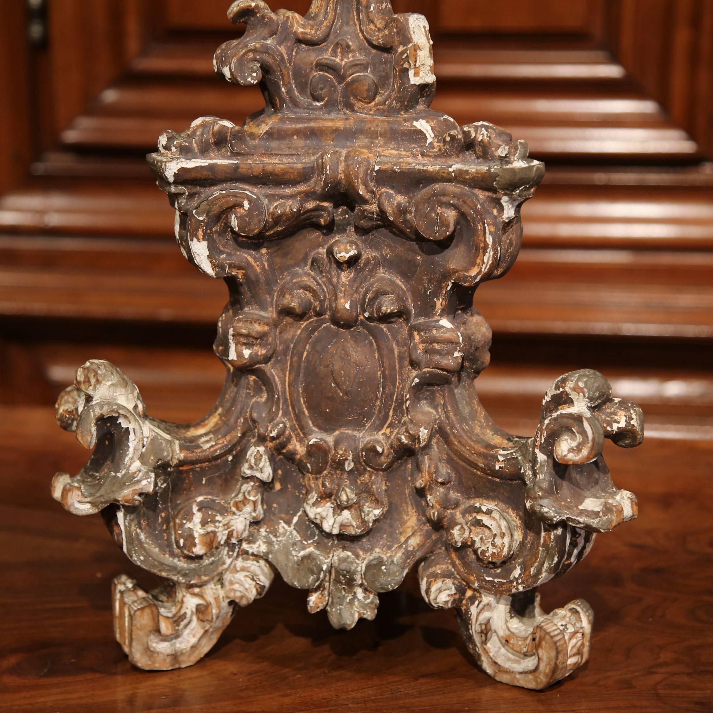 This large, antique candlestick was crafted in Italy, circa 1840. The ornate pricket is embellished with carved cherub faces and sits on three scrolled feet. The entire candlestick is decorated with its original gilt finish, but shows significant