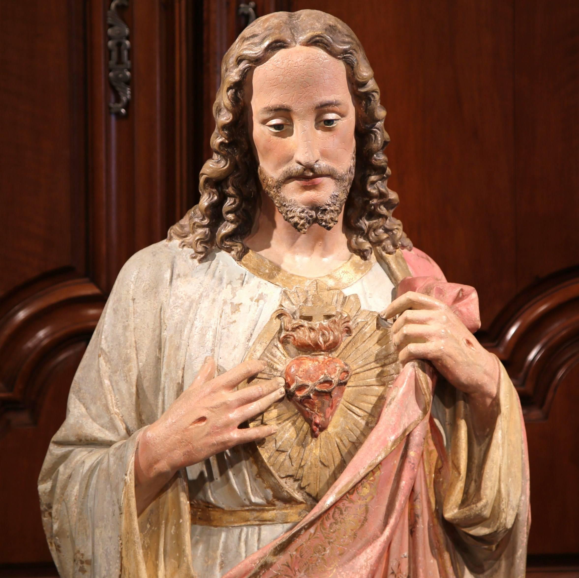 This beautiful, statue of Christ was crafted in Provence, Southern France, circa 1860. The life-size, ceramic sculpture features Jesus standing on a pedestal and showing his Sacred Heart. The large statue has its original painted finish, further