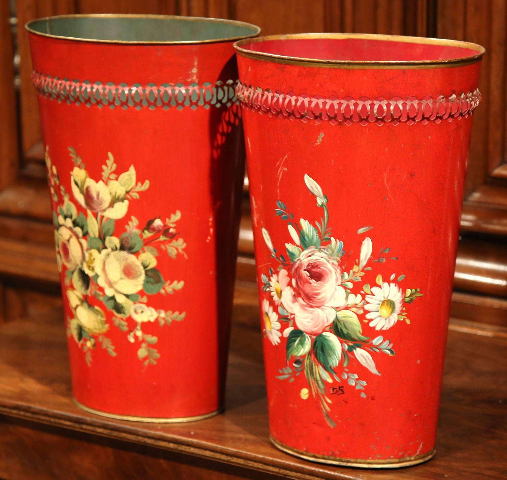 This fine pair of traditional, antique baskets were created in France, circa 1900. The red, decorative waste baskets are hand-painted with colorful flower bouquets with various designs. Each basked is in excellent condition and would make a