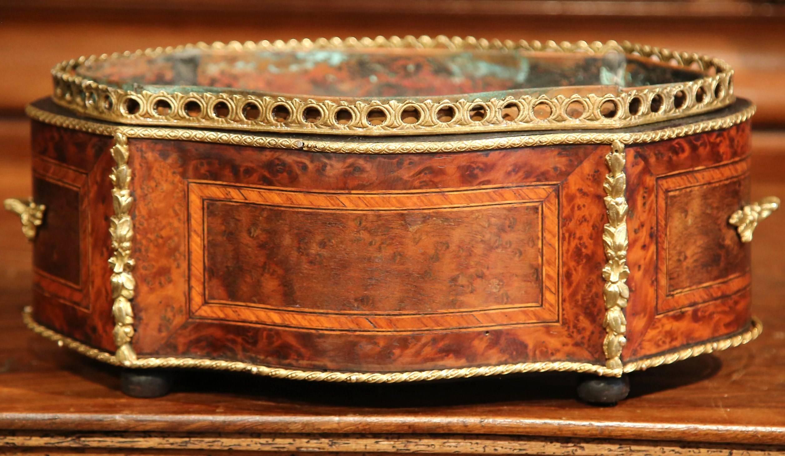 This elegant, antique Napoleon III planter was crafted in France, circa 1870. The oval rosewood jardinière with bronze gallery at the top, features marquetry geometric designs on all four sides, and is further embellished with bronze mounts and