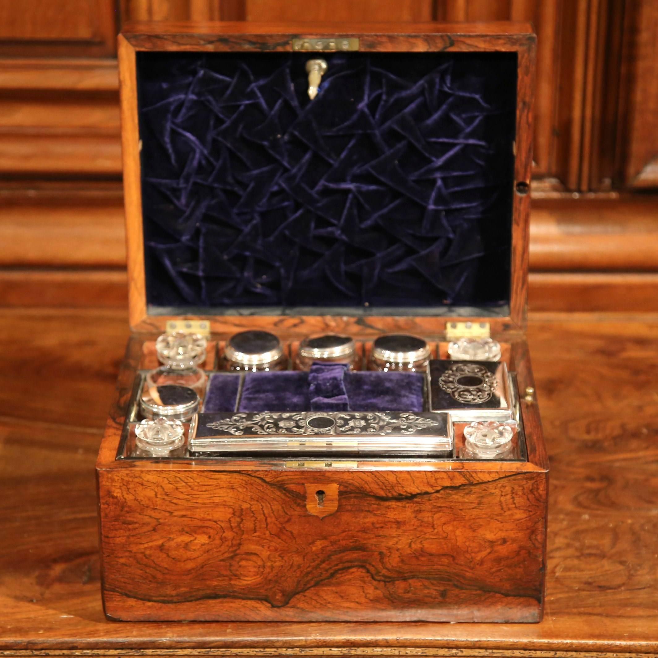 This beautiful antique jewelry box set was crafted in France, circa 1850. The box has a mother-of-pearl crest and several dividers inside. The compartments are outfitted with silver accessories, which include two square cut-glass bottles, three