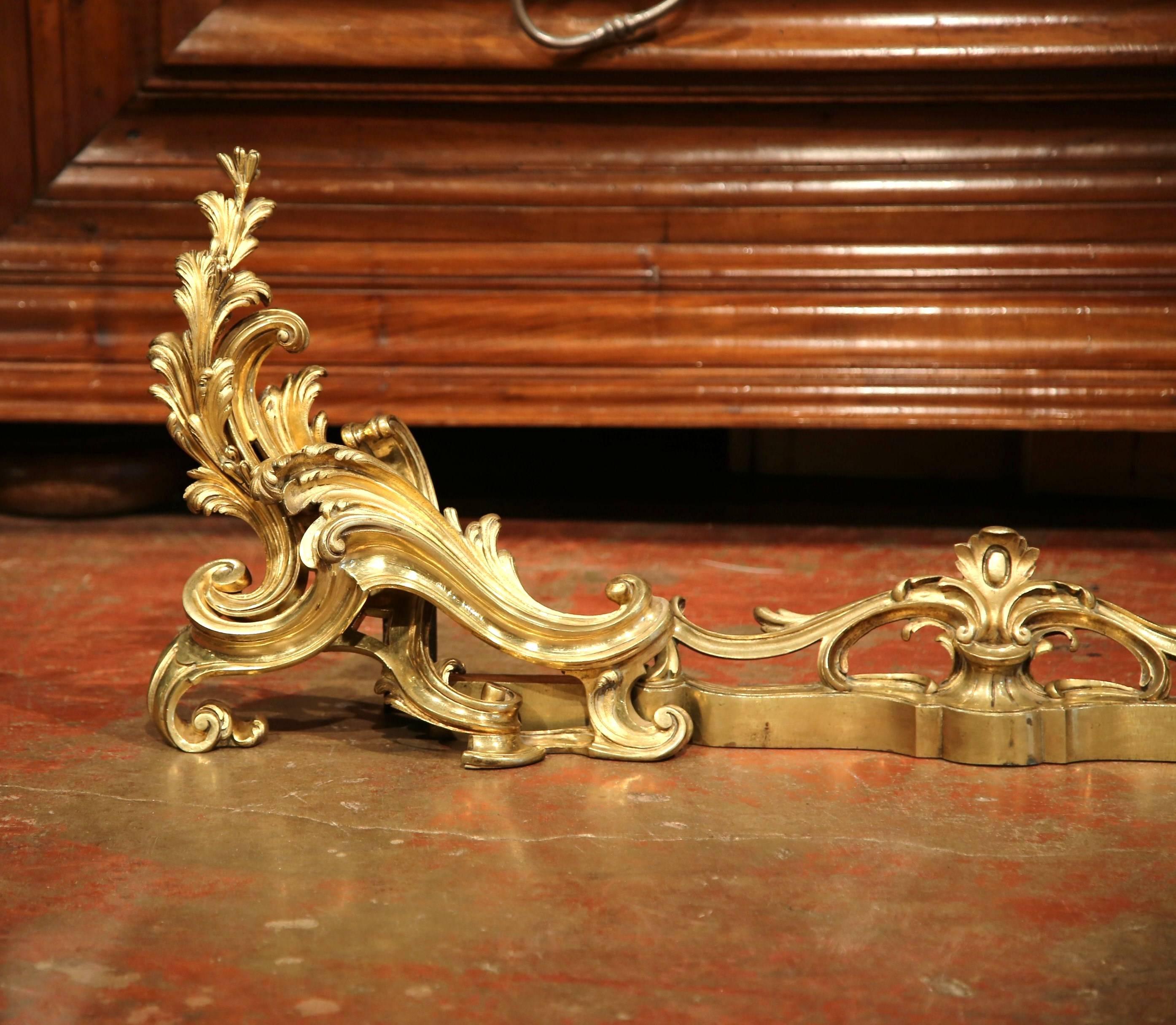 This beautiful, three-piece set would add Classic French elegance to your home. The set is made up of two gilt bronze chenets or andirons and a large, matching fender. Crafted in France, circa 1860, each end piece is decorated with swirling and
