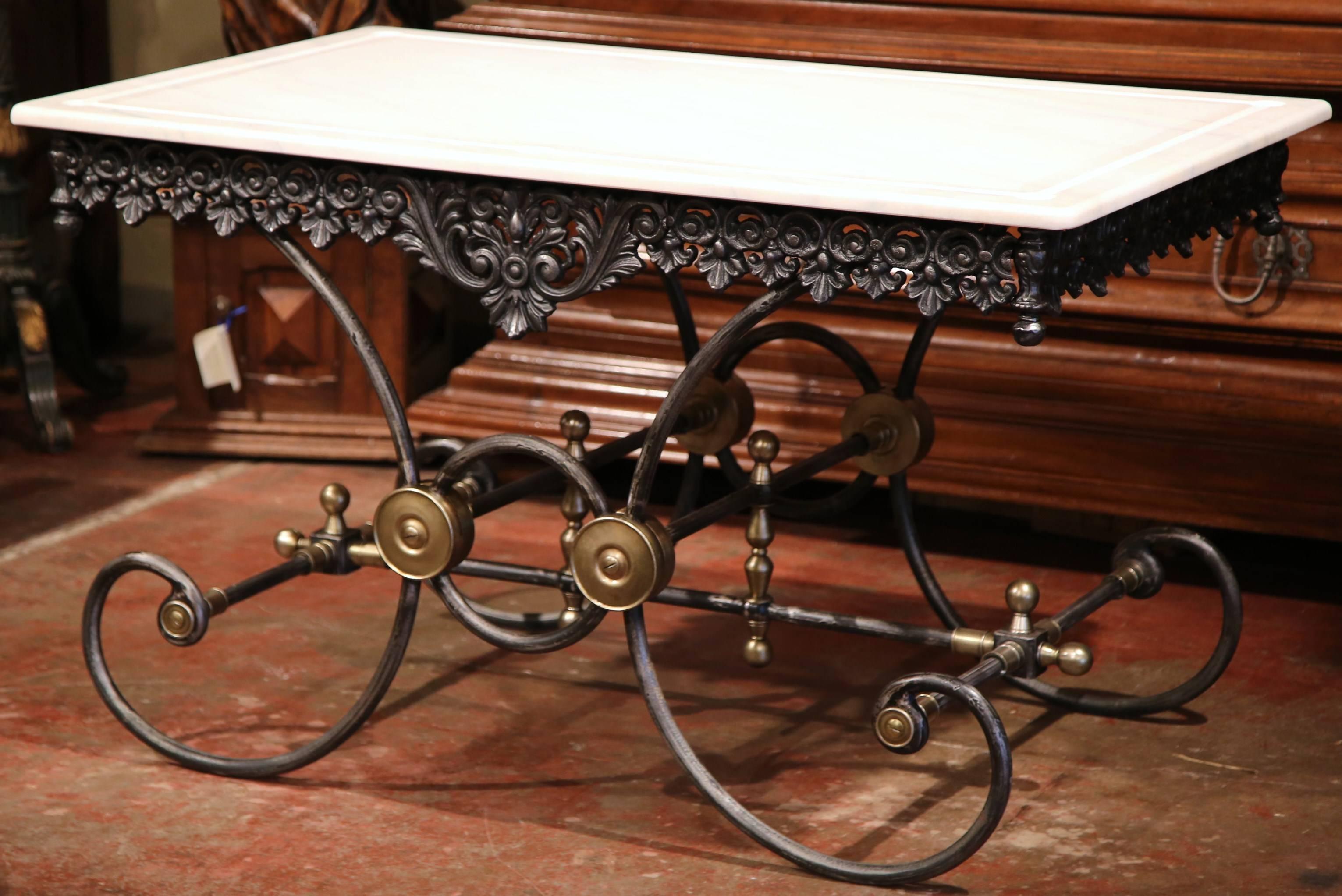 This large butcher table, or pastry table, would add the ideal amount of surface space to any kitchen. Crafted in France, this table has a polished iron finish and intricate metal work throughout the structure. The table has a scalloped apron,