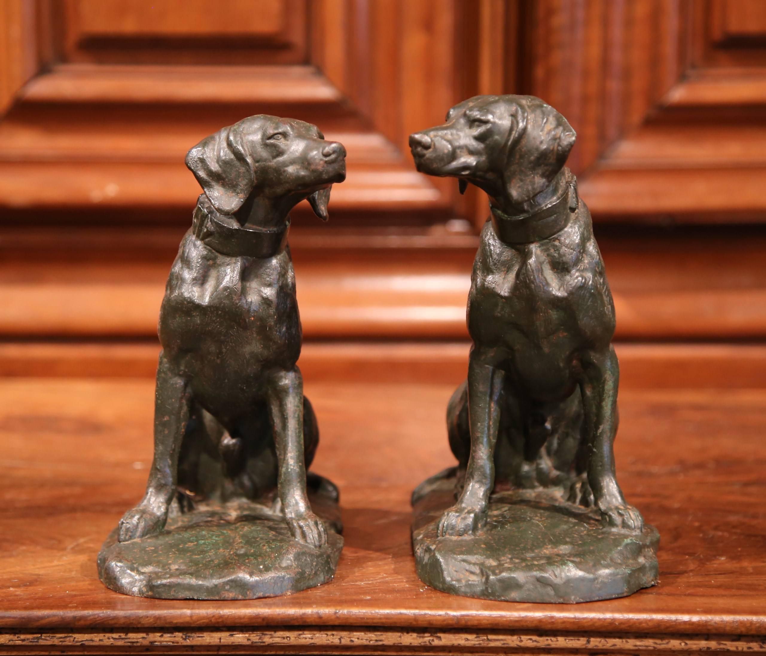 This Fine pair of antique bronze hunting dogs were crafted in France, circa 1860. The Classic dog sculptures feature two Labrador Retrievers with collars sitting on their back feet. These unsigned pieces are in very good condition and have a worn,