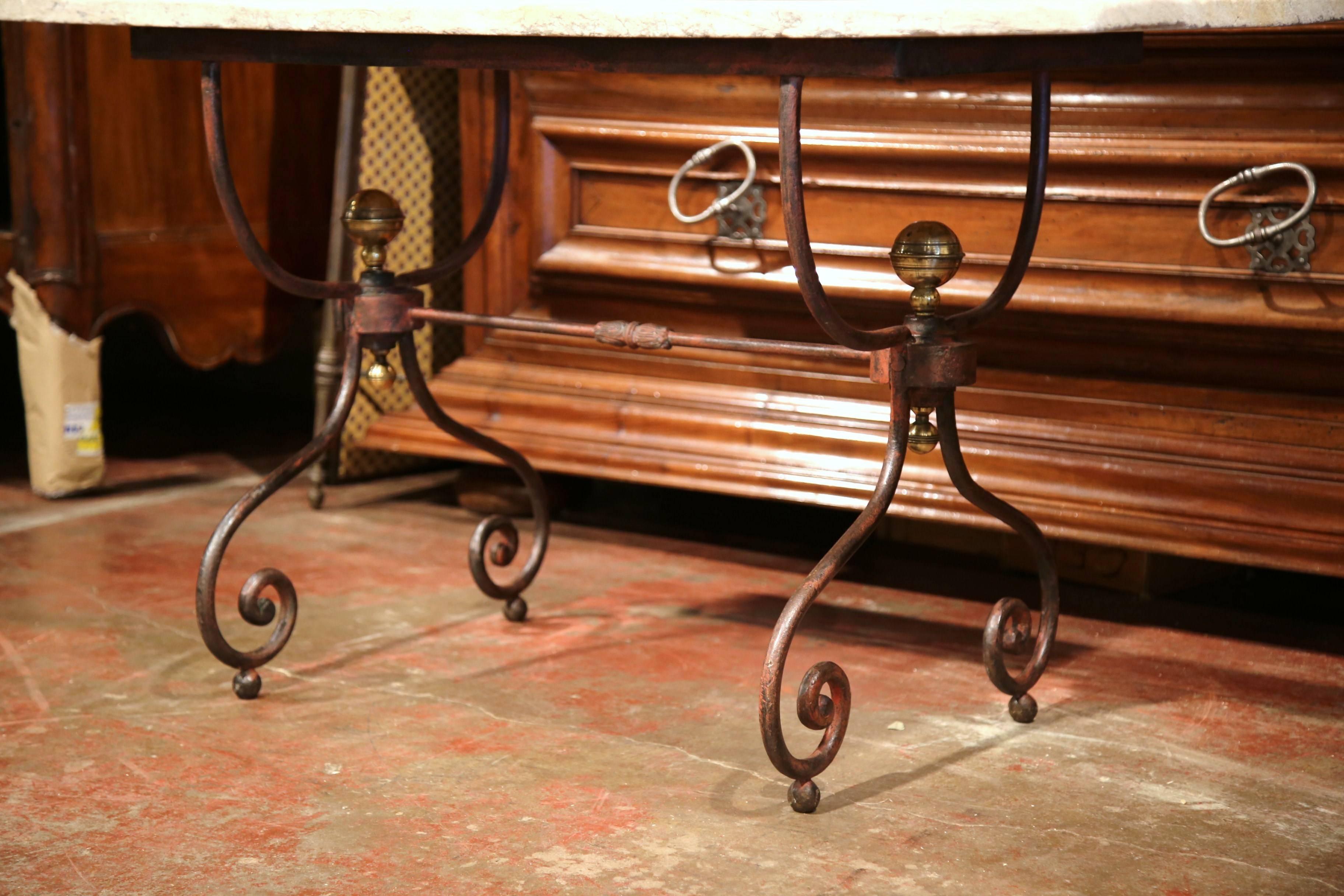 This elegant, antique bistrot table was forged in Paris, France circa 1880. The versatile table could be placed outside or inside, and features two scrolled legs with a stretcher between and decorative bronze finials. The piece has its original