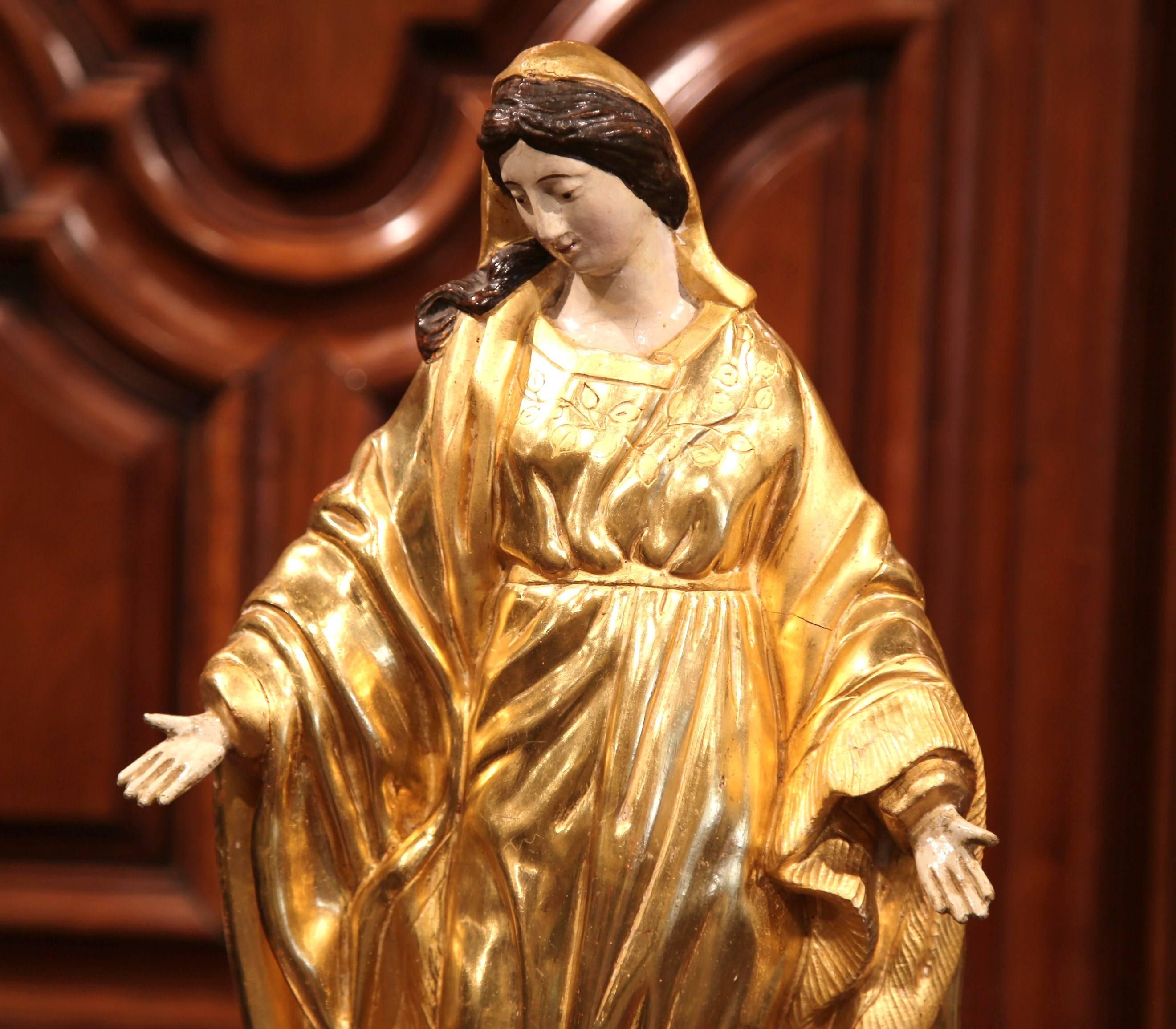 This beautiful, antique sculpture of the Virgin Mary was created in France, circa 1780. Embellished with gold leaf and polychrome finish, the Classic piece is beautifully ornate and also has wonderful details on her robe and throughout her face,