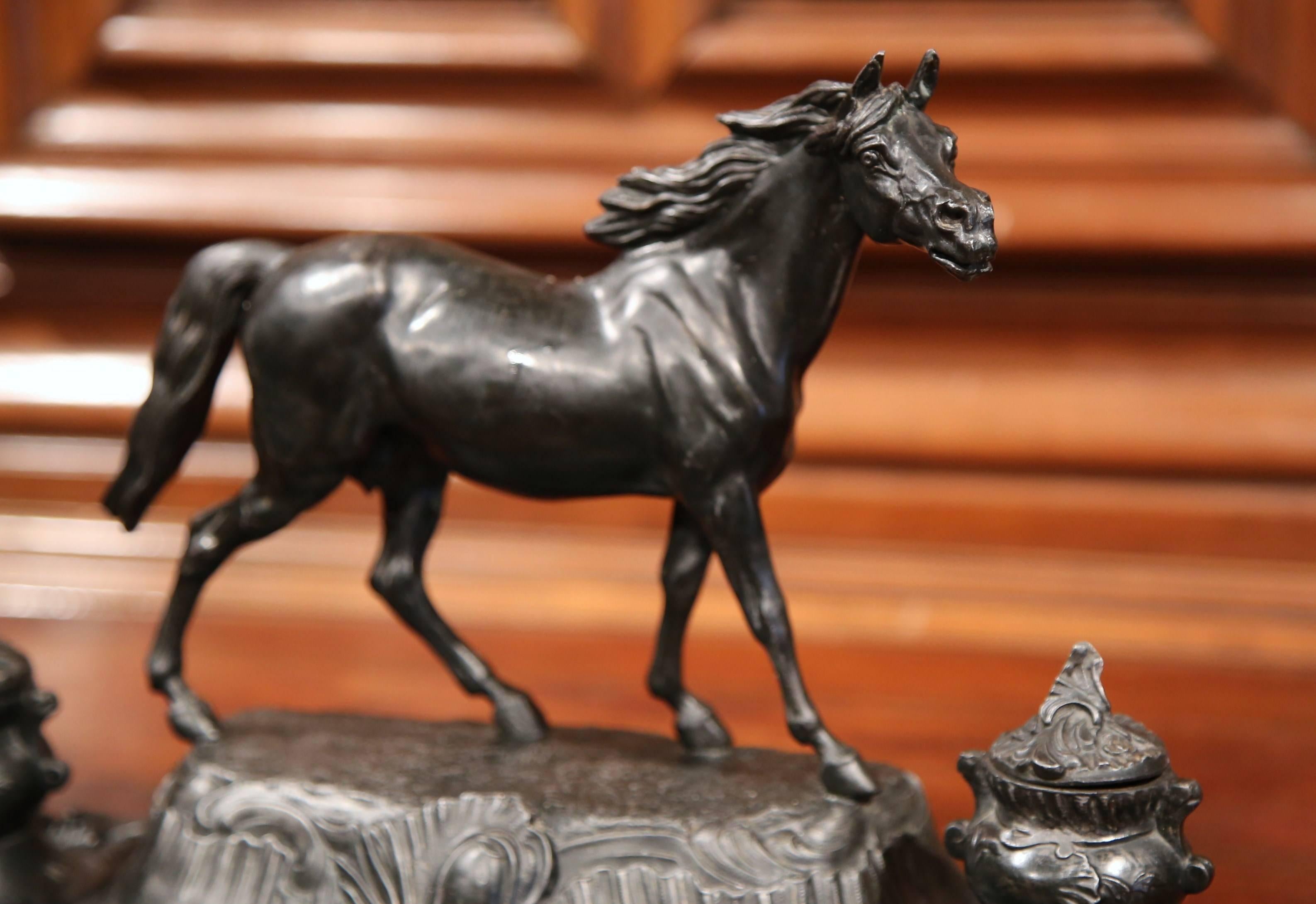 This beautiful, antique horse inkwell was created in France, circa 1880. The desk accessory is made of pot metal and sits on four small curved feet. The office essential features a proud stallion standing on a mount with two ink holders on both