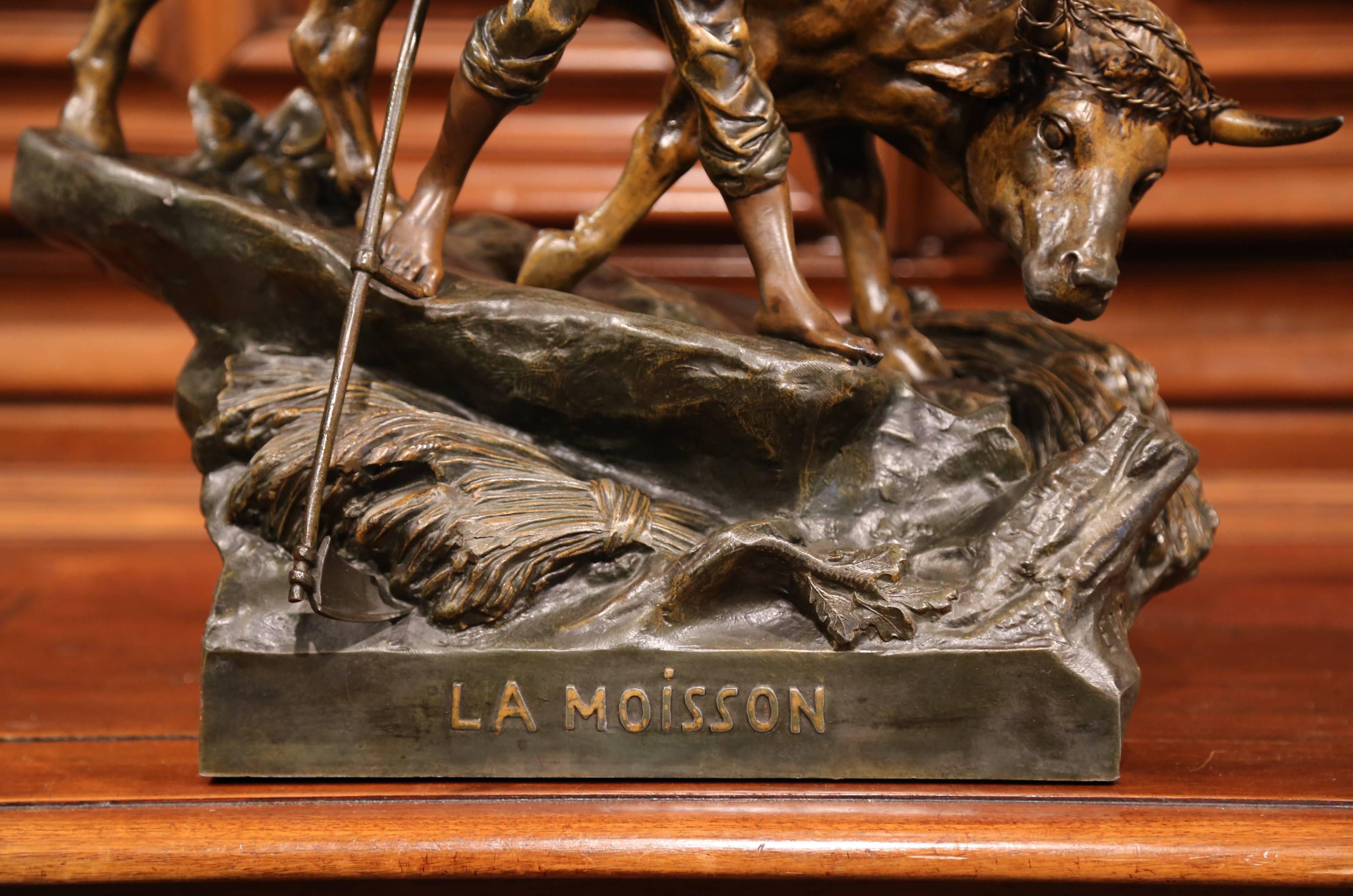 This large, patinated white metal sculpture was crafted in France, circa 1880. The antique composition features a farmer holding his bull during the wheat harvest. Both man and bovine figures are standing on rocky ground further decorated with a