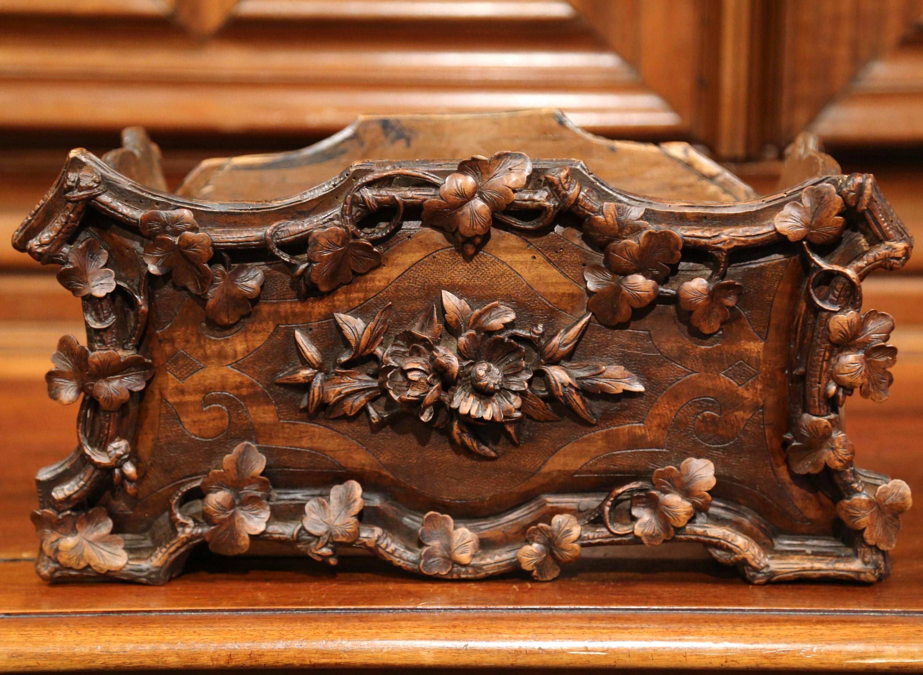 This beautiful antique black forest jardiniere was crafted in France, circa 1880. The rectangular fruit wood planter features hand carved flowers, acorns, branches and leaves on all four sides. The jardiniere also has detailed marquetry design with