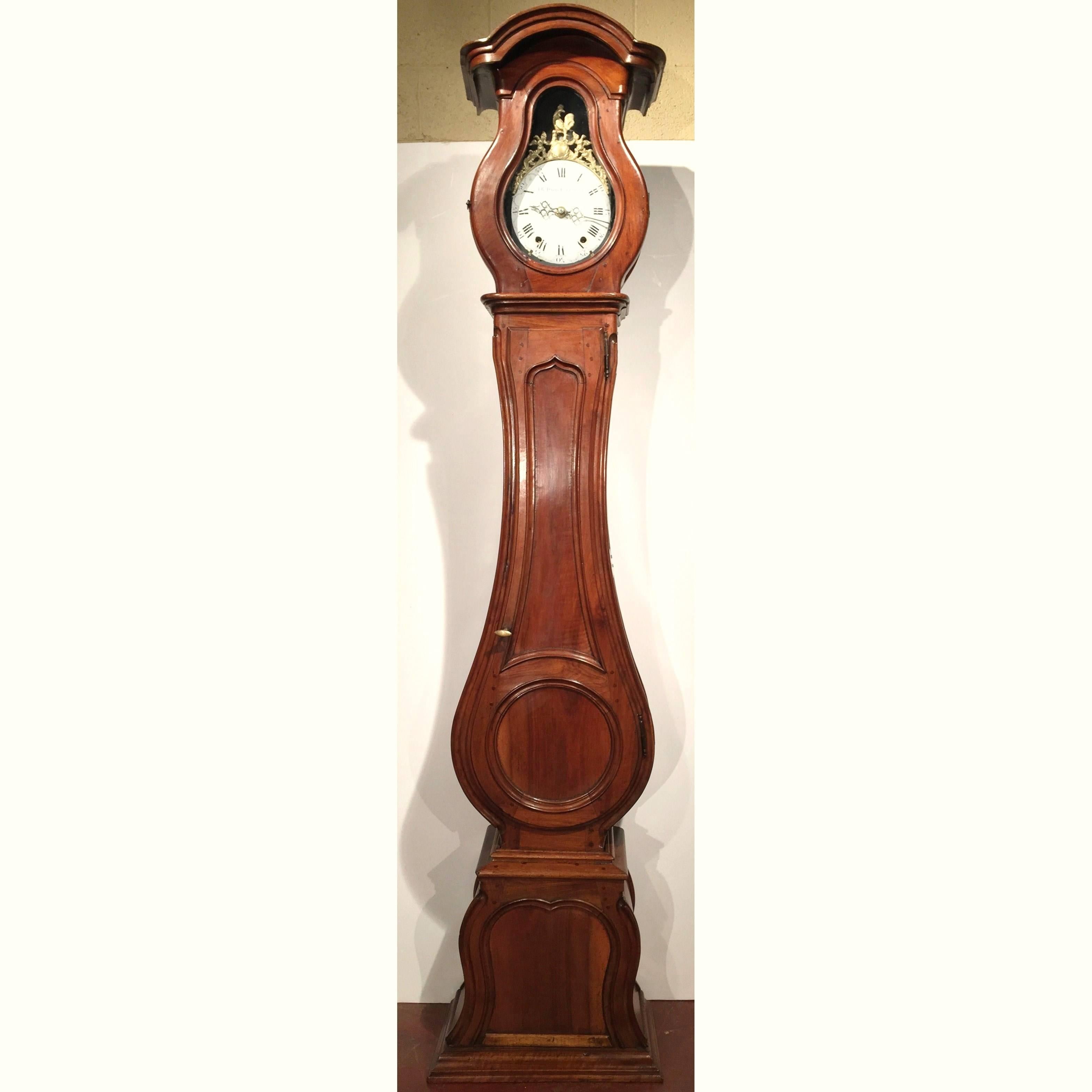 Place this elegant antique long case clock in an entry or breakfast room. Crafted in Lyon, France, circa 1760, the fruitwood grandfather clock sits on a flat bottom plinth and features beautiful carved lines embellished with an arched bonnet top,
