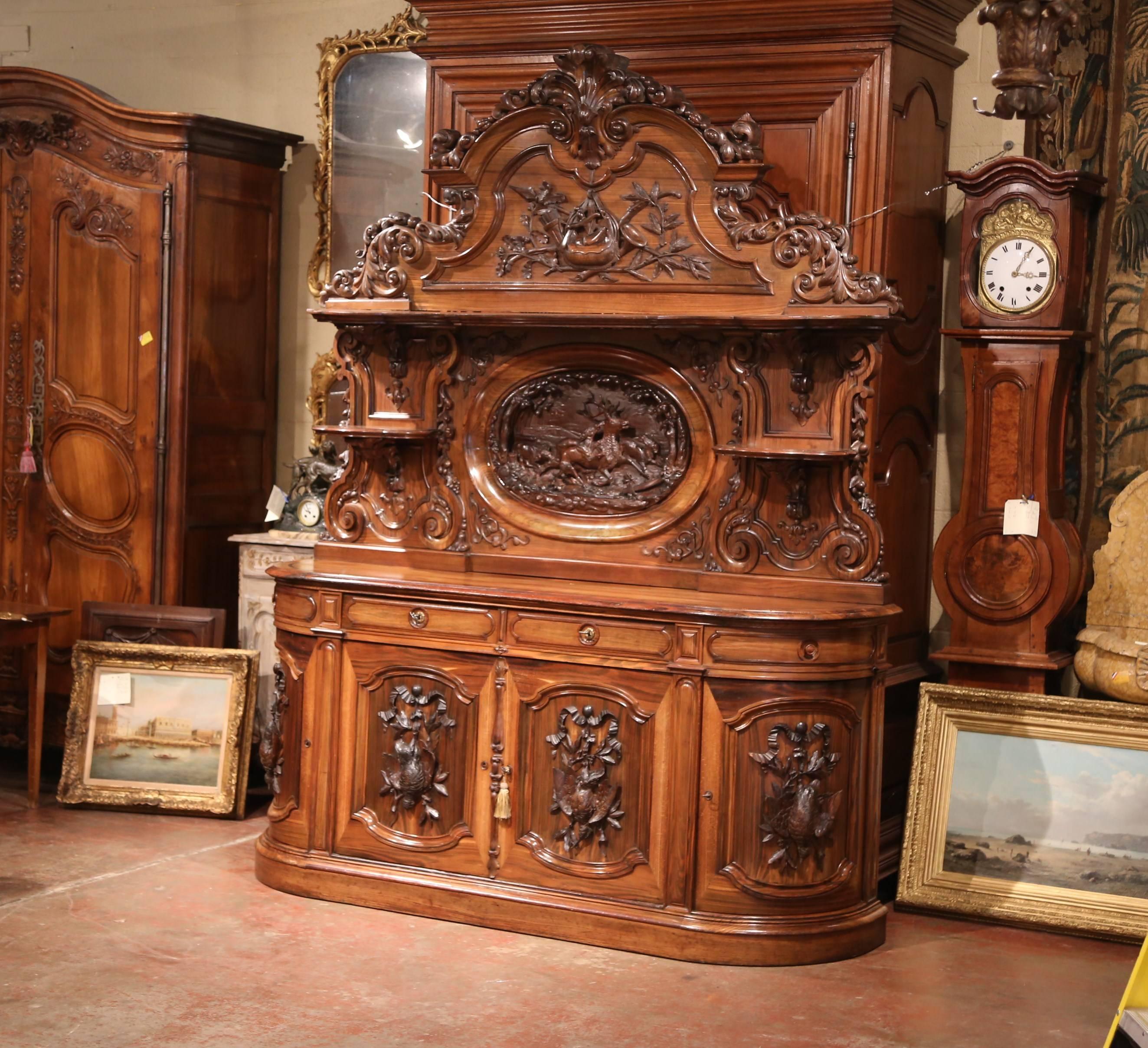 This important, antique Black Forest sideboard was crafted in France, circa 1850. The unique, highly detailed cabinet made of three sections, features exquisite carvings throughout, including a center oval medallion hunting scene with running dogs