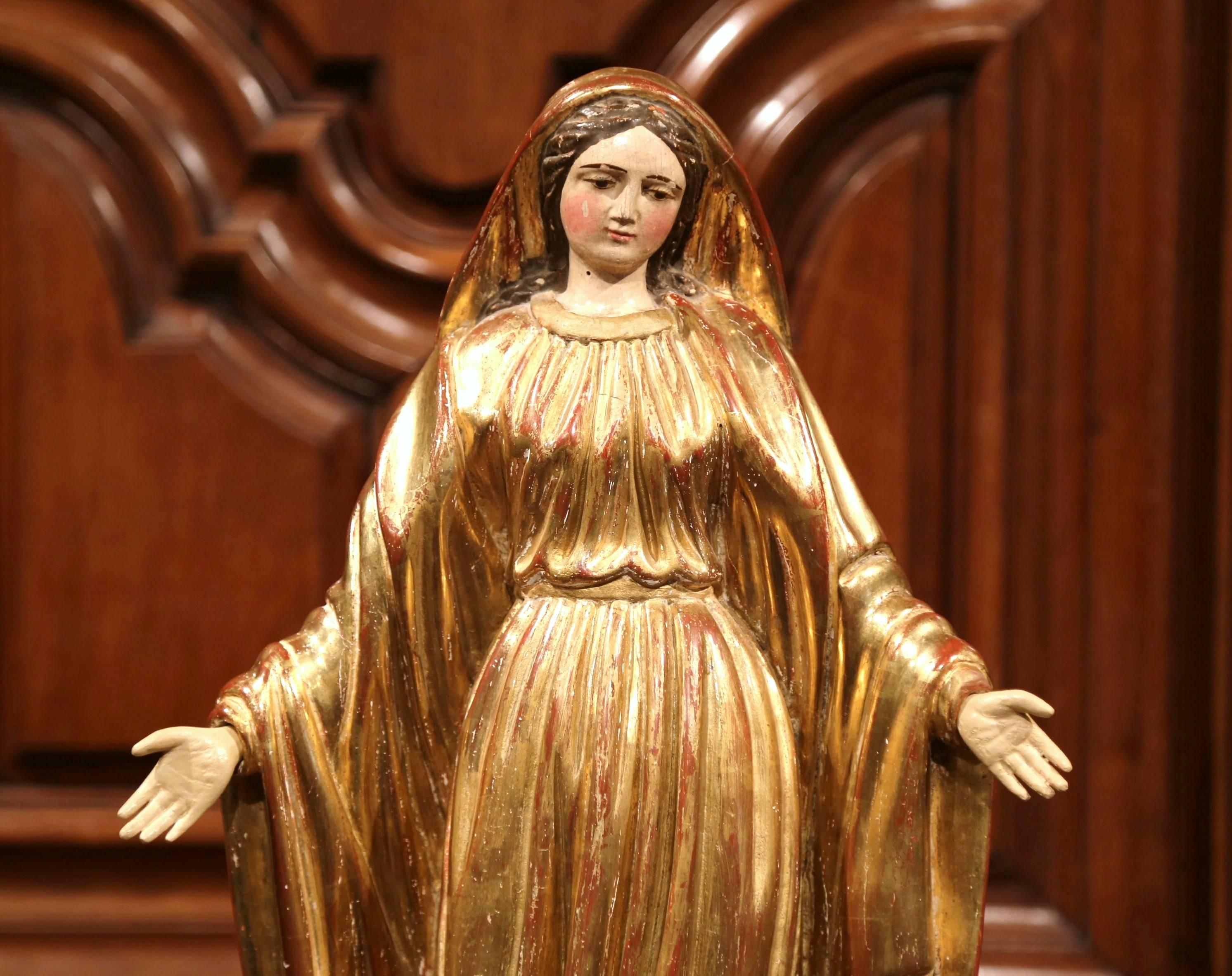 This beautiful, antique sculpture of the Virgin Mary was created in France, circa 1780. Embellished with gold leaf and polychrome finish, the Classic religious figure is beautifully ornate and has wonderful details throughout her robe, face, hair