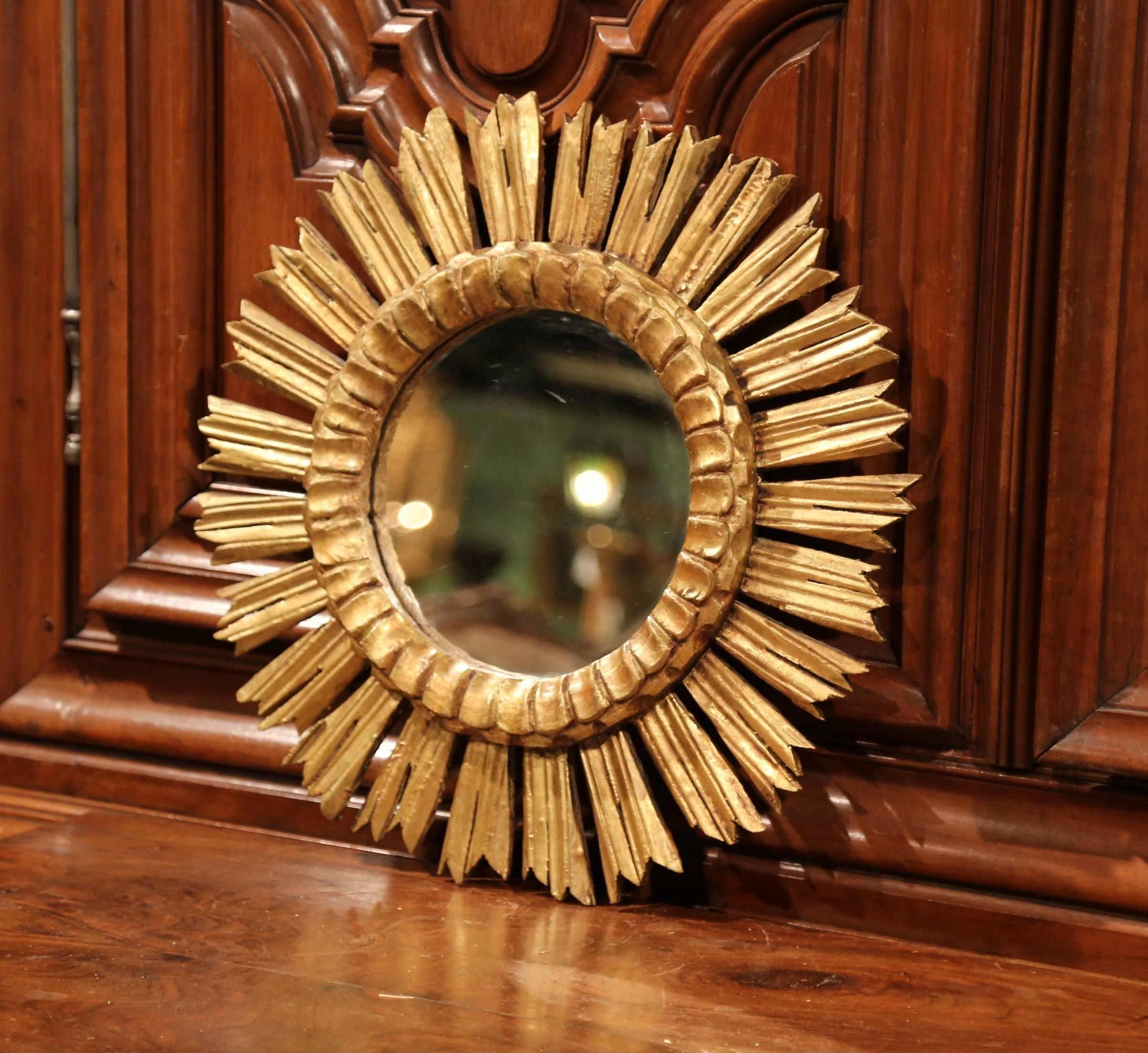 Create a focal point in any room with this gleaming, sun mirror from France. Hand-carved circa 1940, the midcentury piece is decorated with intricate carvings throughout and resembles the shape and shining quality of the sun. The round piece is in