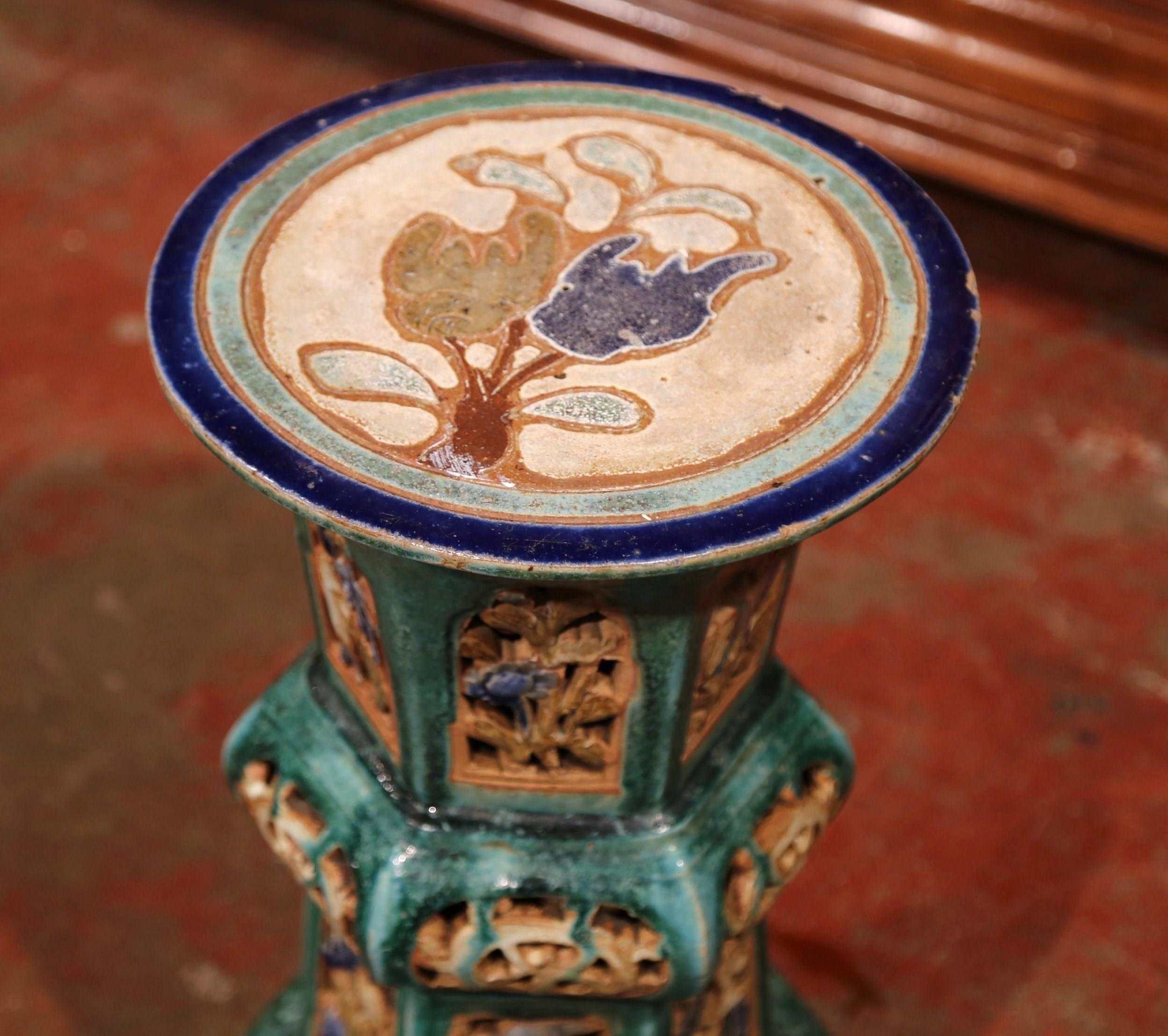 This interesting, porcelain garden seat was sculpted in France, circa 1920. In the green and brown palette, the round top has colorful painted flowers with intricate design on the base. This unique stool is in excellent condition and would make a