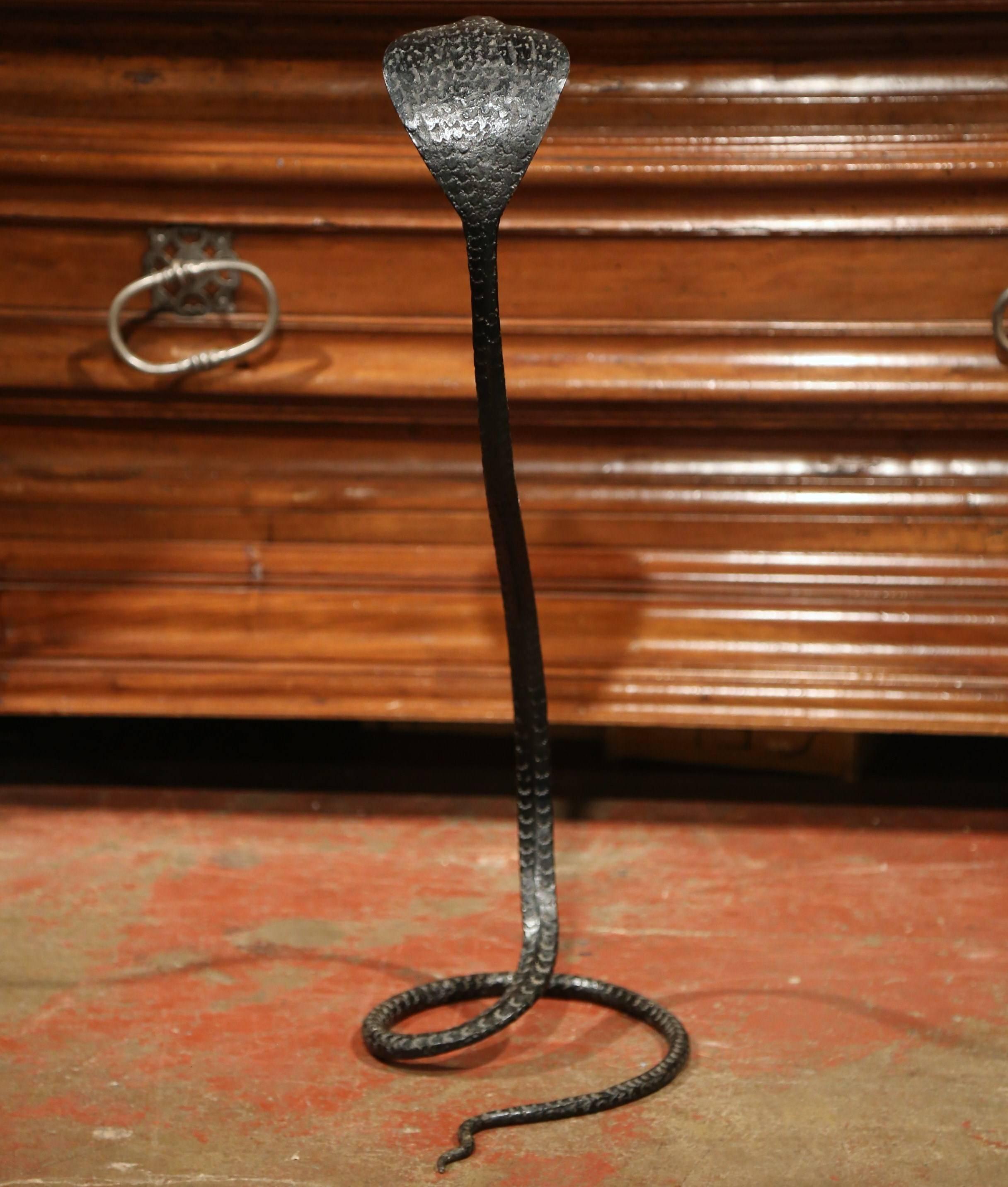 This interesting, decorative snake sculpture was forged in France, circa 1950. The simple sculpture features a rattle snake standing up. The piece is in excellent condition with wonderful iron work and rich black painted finish throughout. This