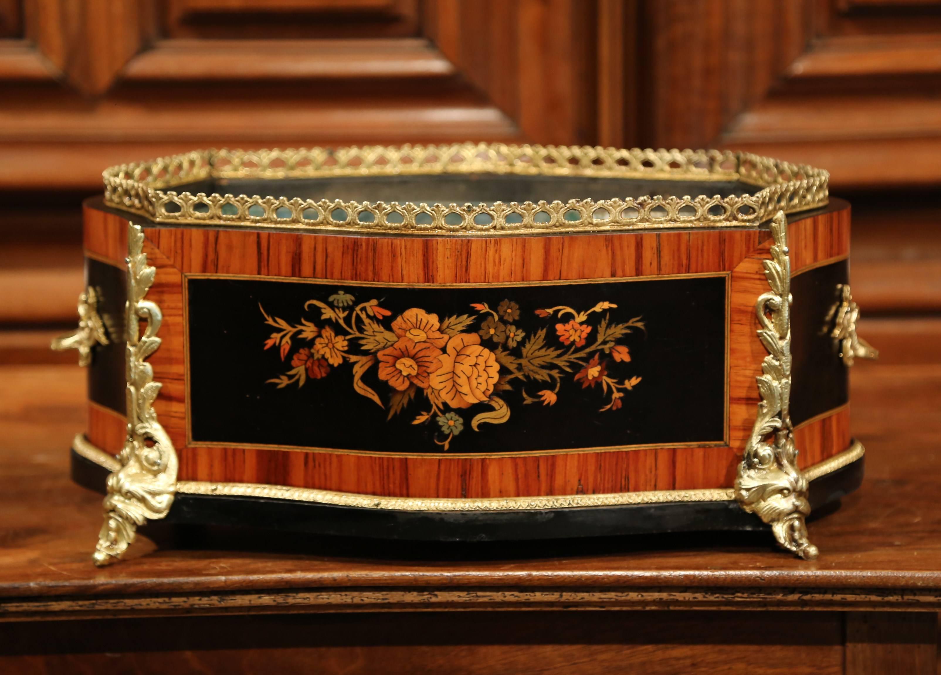 This beautifully crafted, oval Napoleon III fruitwood planter was crafted in Paris, France circa 1870. The antique, rosewood and ebony jardiniere features wood marquetry and parquetry work with a very detailed inlay of colorful flowers and leaves on