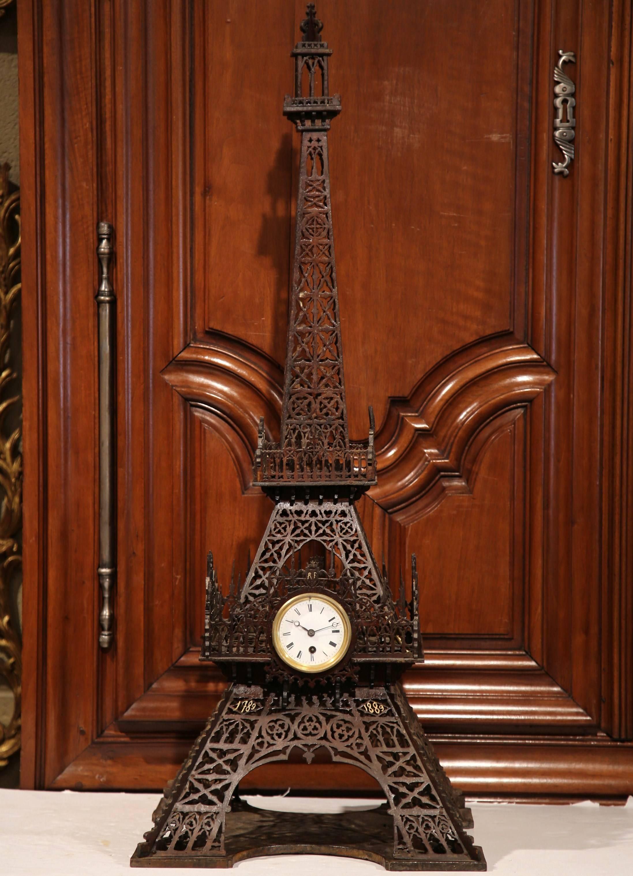 Decorate a shelf or mantel with this grand, antique, carved replica of the Eiffel Tower. Crafted in France circa 1890, the symbolic, intricate architectural symbol is embellished with the original center clock; the movement has been cleaned and