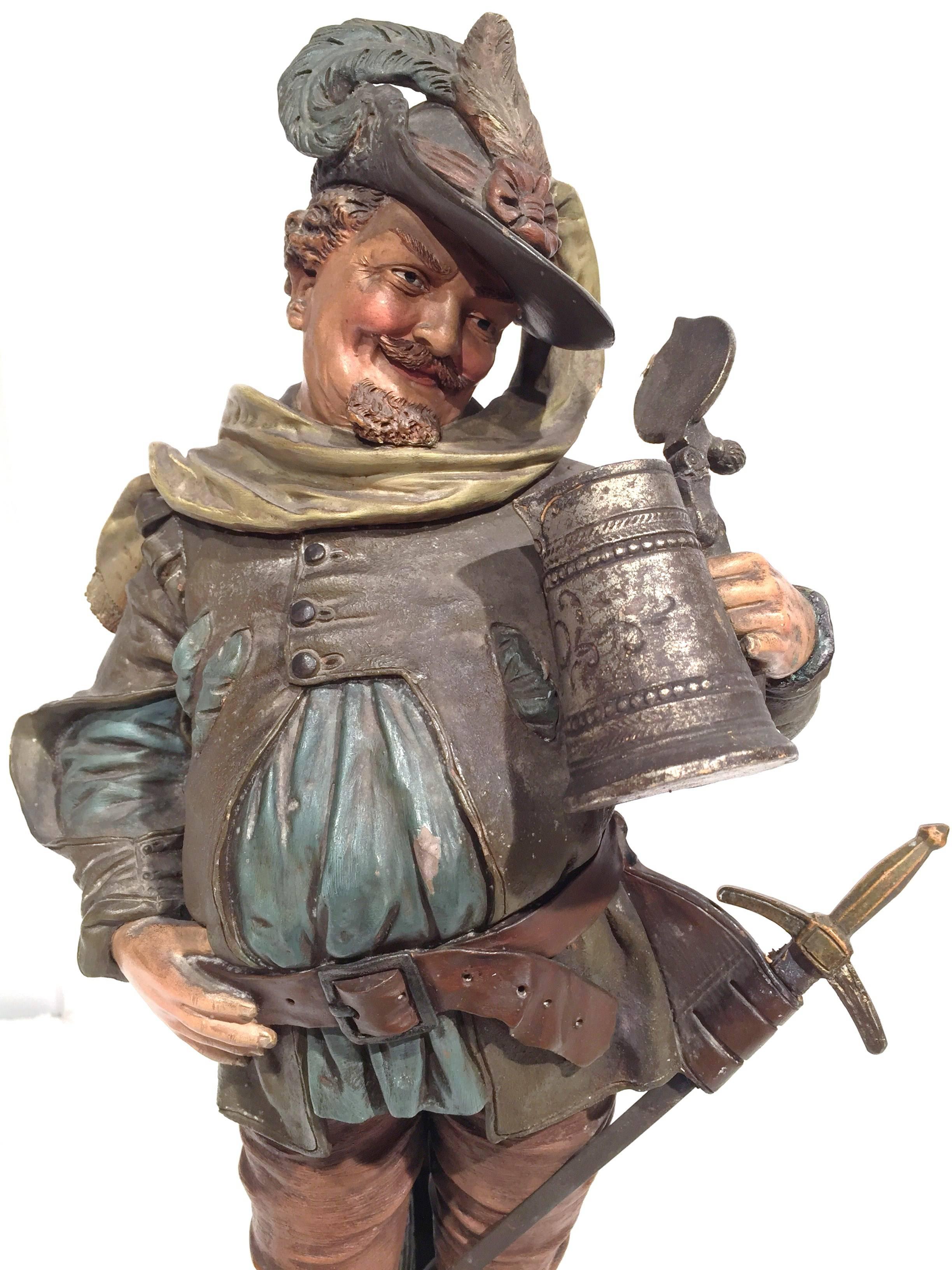This antique musketeer terracotta figurine was created in Northern France, circa 1890. The 