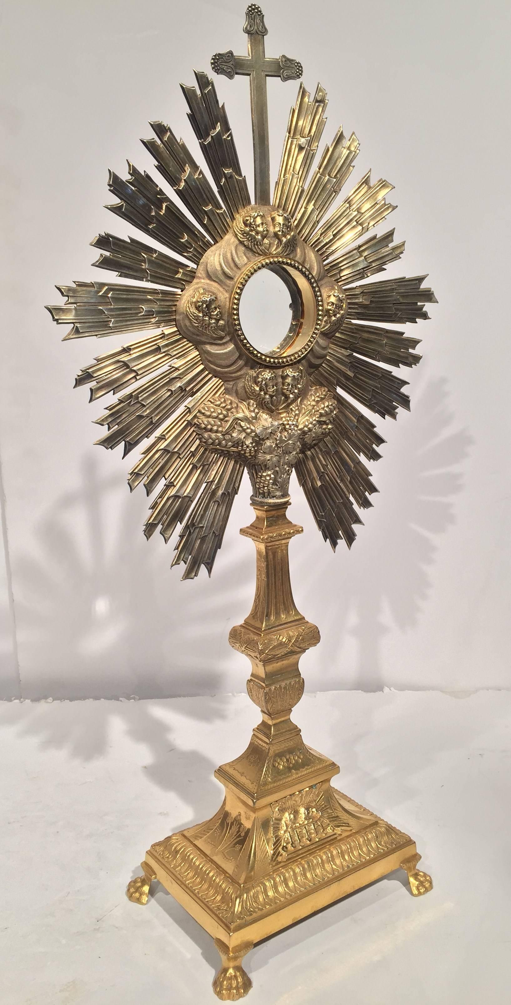 Very fine 18th century French bronze and copper catholic ostensoir (monstrance) (circa: 1780), depicting from top to bottom: the cross, the sun, 6 angels, wheat, vines, grapes and lamb.
A ostensoir or 