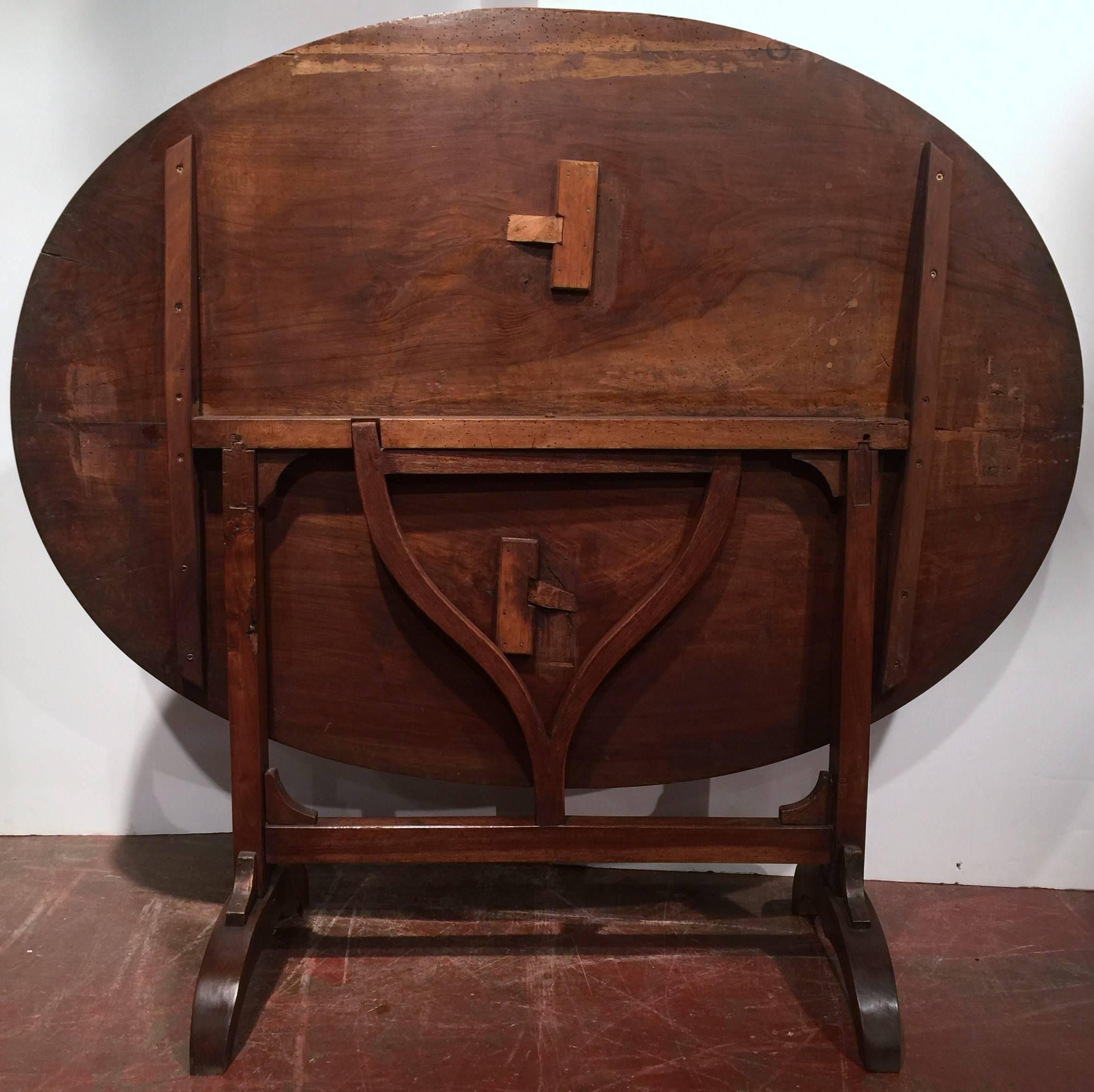 Fine antique walnut wine tasting table from Burgundy, France (circa: 1860).  The large tree was split right in the middle to achieve such a wonderful top! Great condition with beautiful patina!