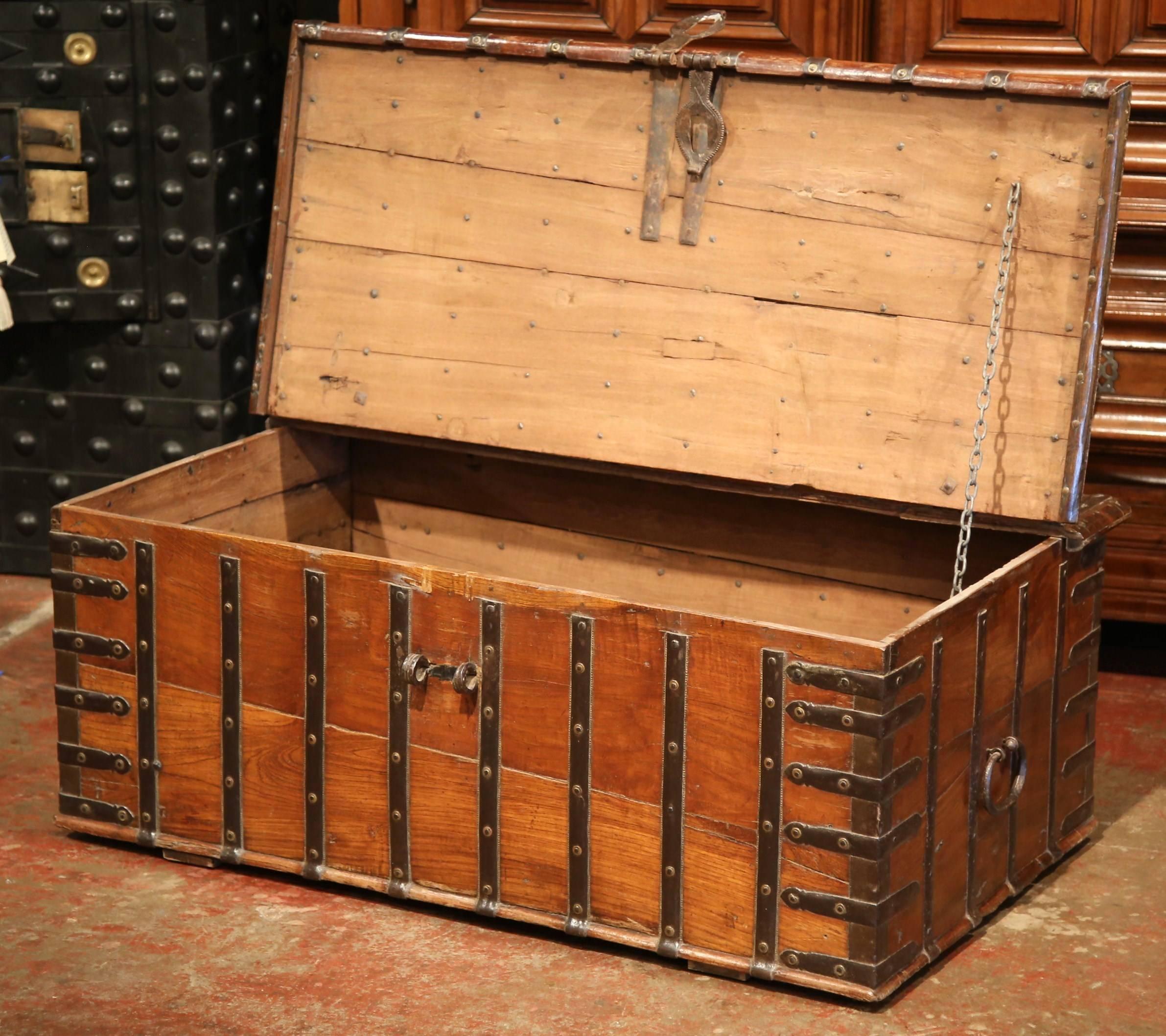 This fruitwood coffee table trunk was crafted in England, circa 1870. The wooden antique blanket chest is finished on all four sides, and has heavy hardware and metal strapping. The piece opens from the top and features a salt box on the inside