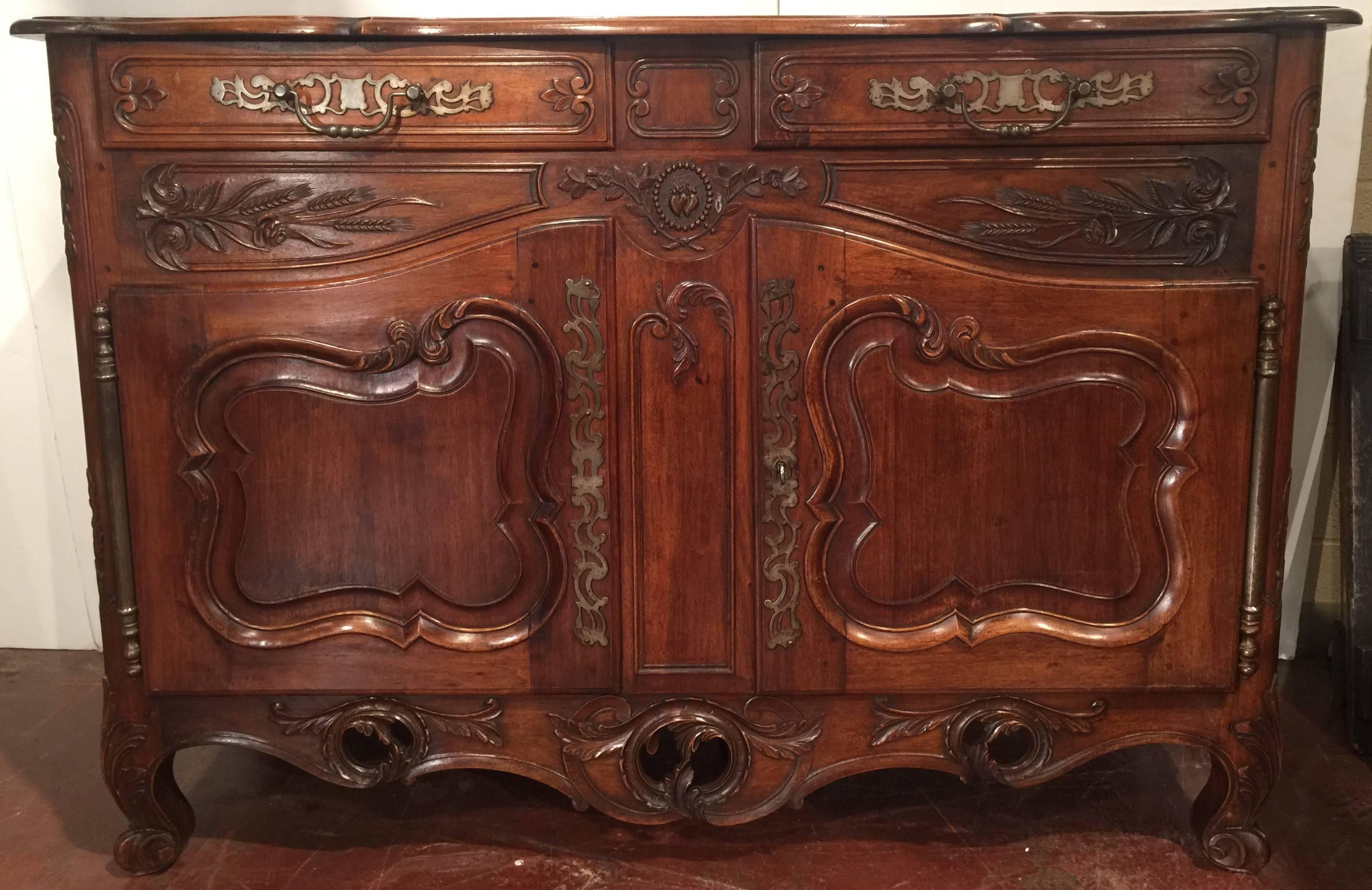 Elegant antique Louis XV fruit wood buffet from Provence, France, circa 1880. Beautifully carved with heavy hardware, this cabinet features 2 upper drawers and double doors underneath for storage.
