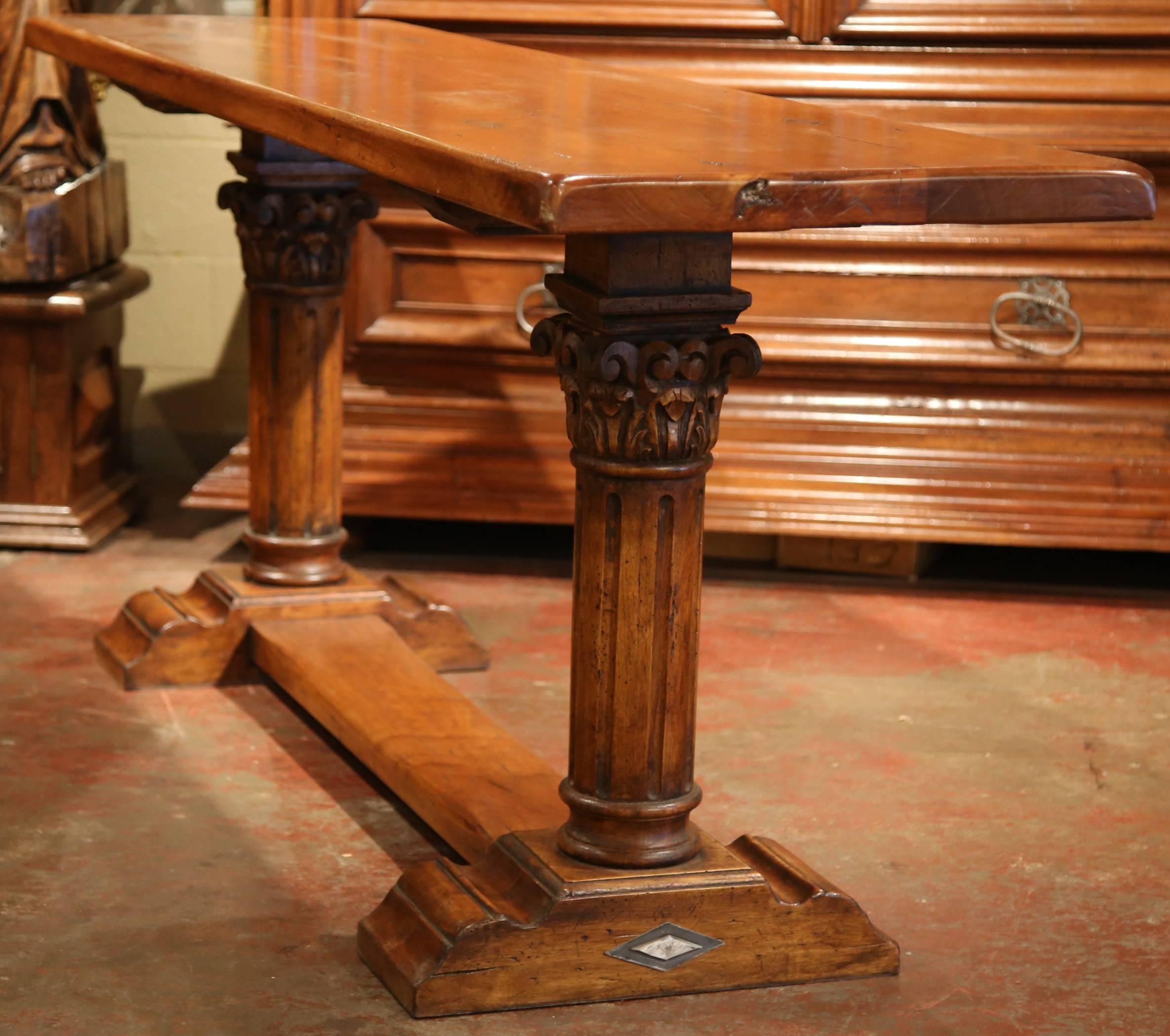 This long, elegant fruitwood table has a slim profile and is in the Baroque style of Louis XIV. The console is made with antique fruitwood, has nicely hand-carved legs with a wide stretcher in between, and is embellished by large diamond shaped