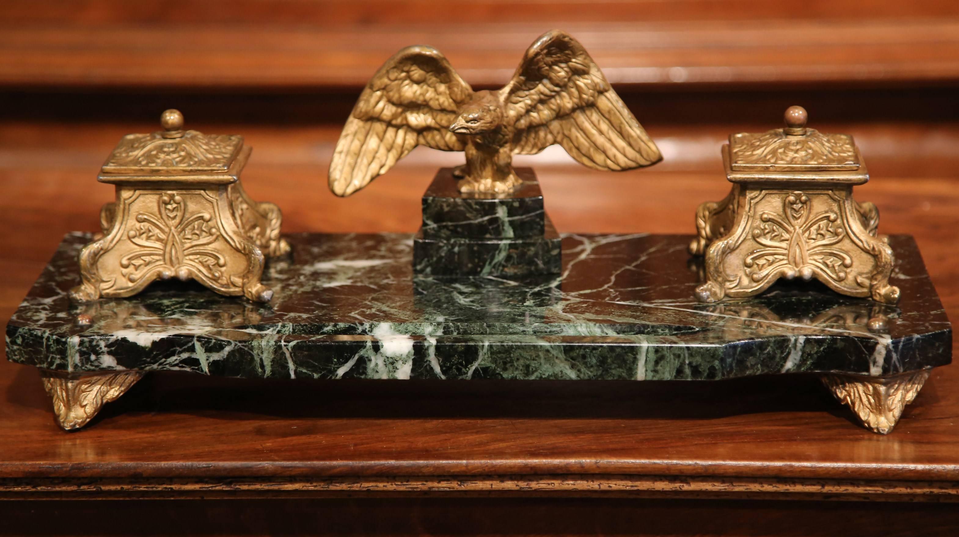 Decorate your desk or office with this large inkwell on a green marble base. Crafted in France, circa 1920, the antique desk accessory stands on small scroll feet and features a bronze eagle standing between the two square bombe metal ink holders