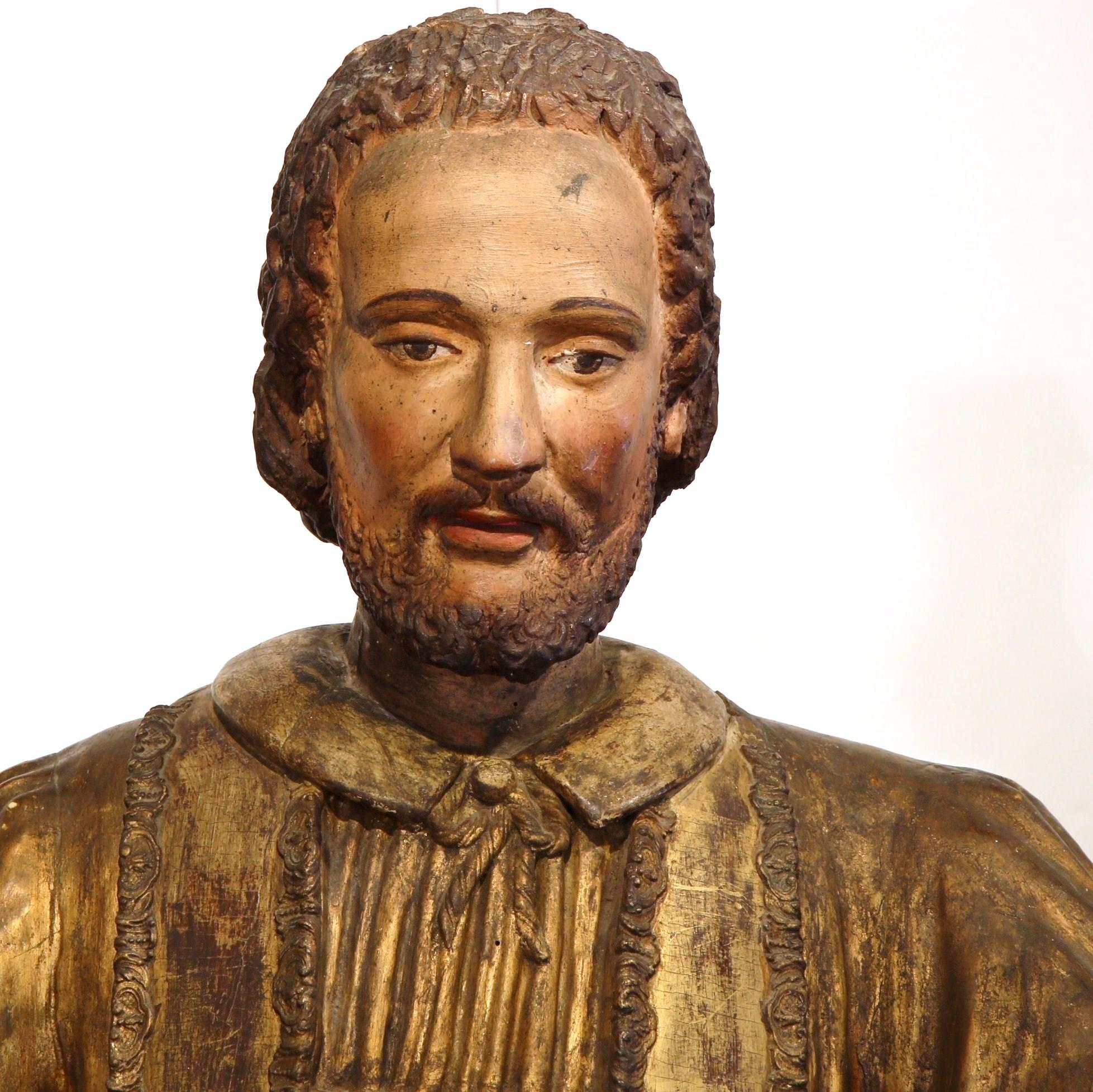 This beautiful, life sized wooden statue of Saint Francois Xavier was crafted in Spain, circa 1790. The antique sculpture features wonderful details on the Saint's ornate clothing, which includes an engraving on both sides of his stole (vestment).