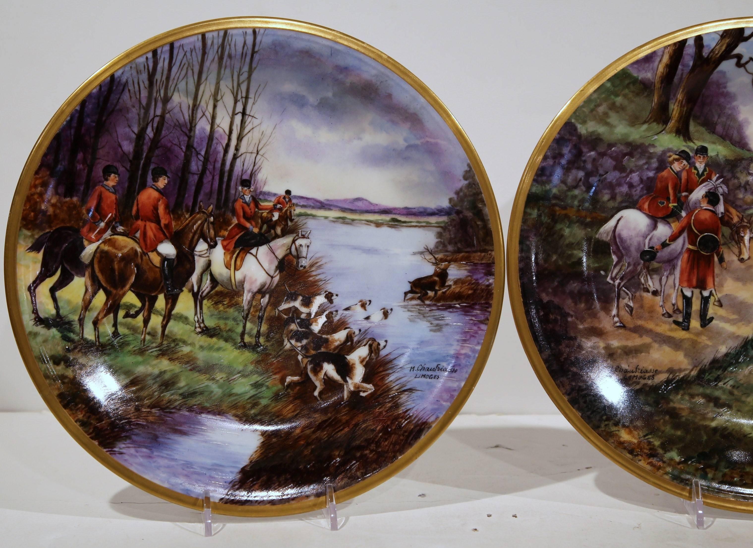 Beautiful and colorful pair of antique plates from Limoges, France, circa 1890 depicting two hunting scenes with dogs, horses and hunting horns. Completely hand-painted with gold rim and signed on the front by French designer Marcel Chauffriasse.