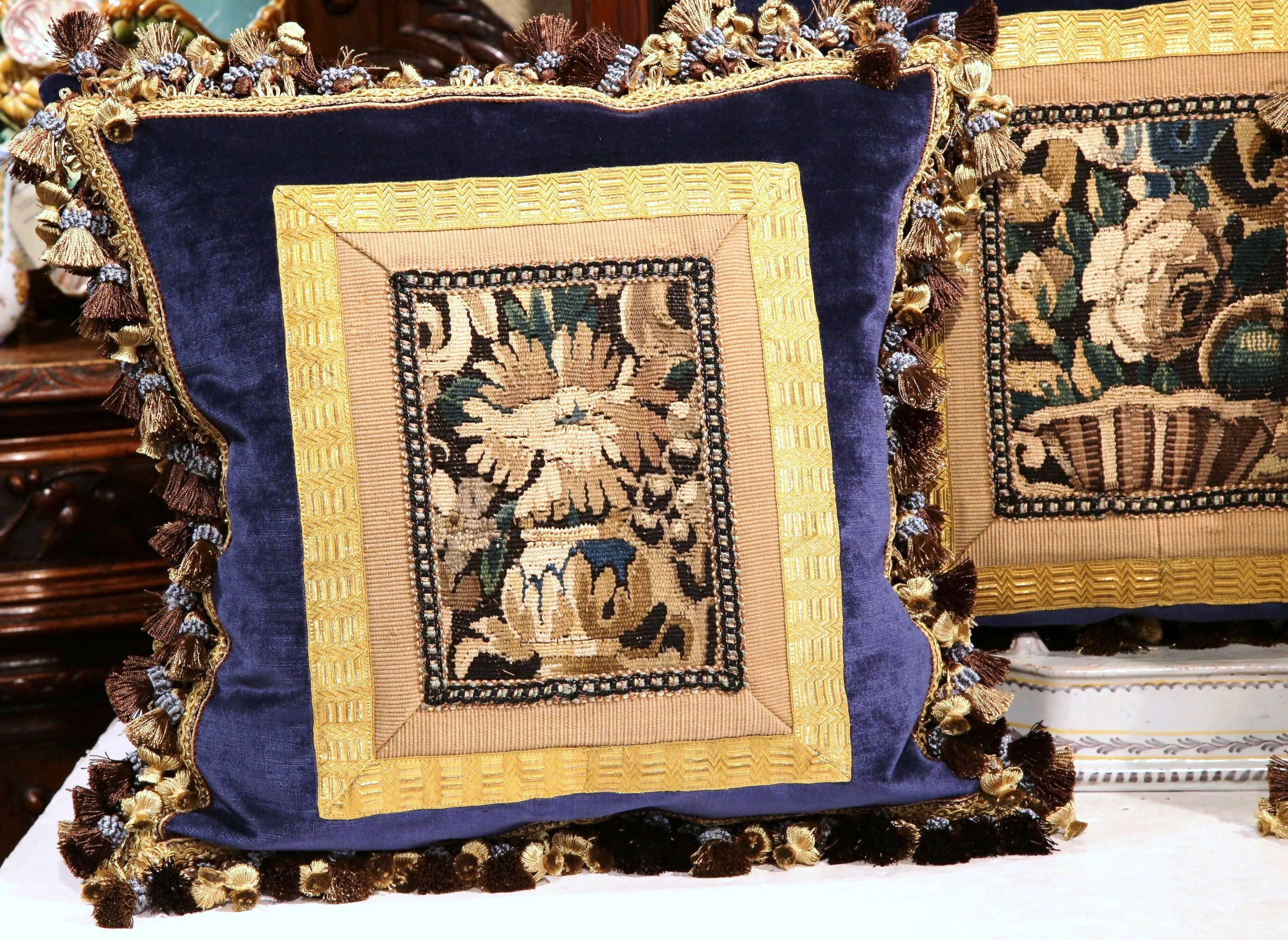 Decorate a sofa or a bed with this beautiful set of three pillows made with 18th century tapestry fragments from Aubusson, France. Each cushion features antique gold trim, blue velvet, elaborate fringe and tassels, and is filled with comfortable