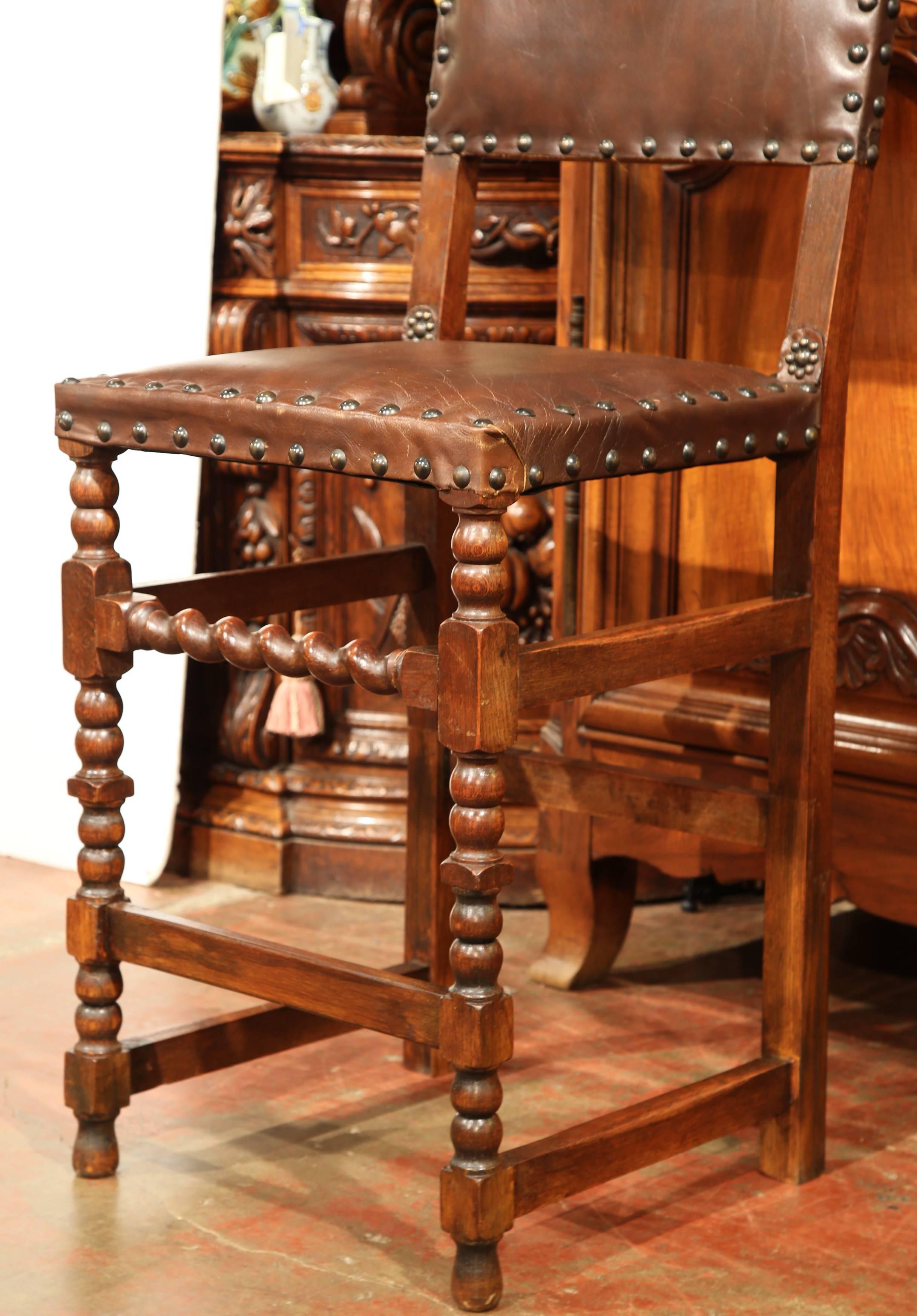 Decorate a kitchen counter with this pair of antique stools. Crafted in France, circa 1870, the large fruitwood chairs have been raised with a seat height at 29