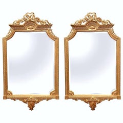 Pair of Mid-20th Century Louis XVI Carved Giltwood Mirrors with Bevelled Glass