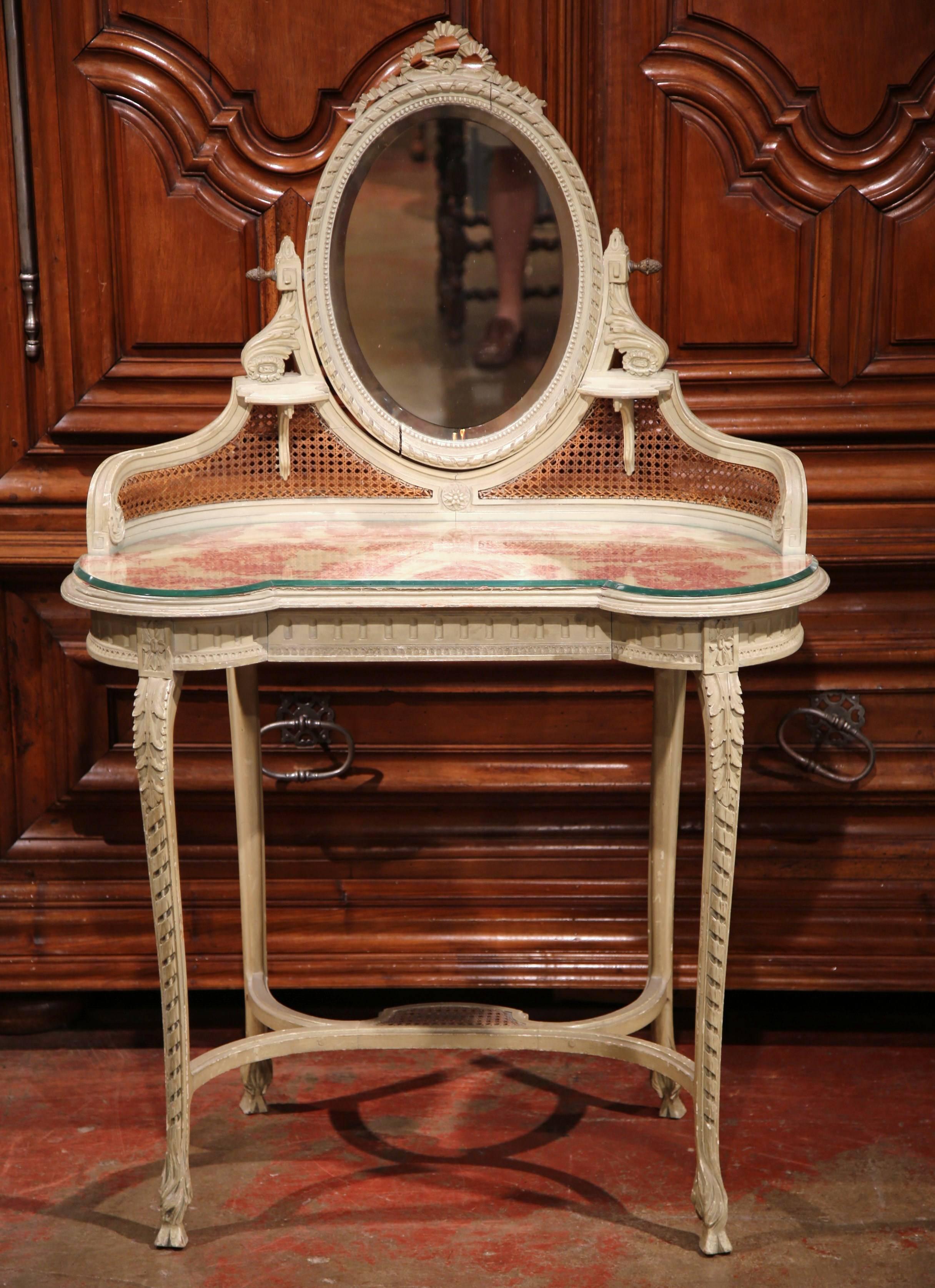 Add French elegance to your bathroom or bedroom with this antique vanity from Versailles, France, circa 1880. The French coiffeuse features a swivel oval beveled glass mirror adjustable with two side brass knobs, and a wide drawer across the front.