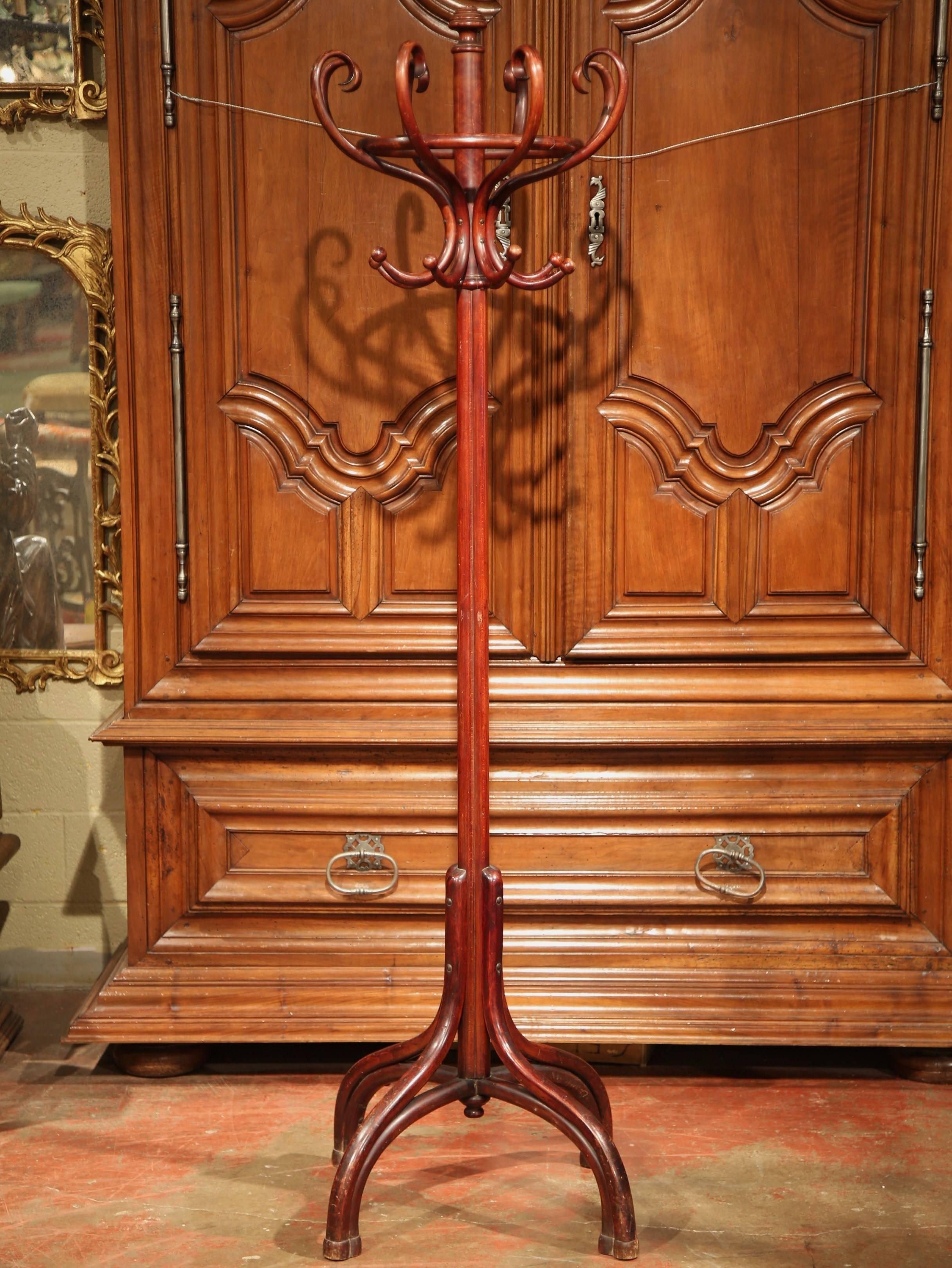 Bring a retro, yet practical touch to any entry or dressing area with this elegant, carved coat stand. Created in Paris, France, circa 1920, the wood hat rack is very utilitarian with two rows of eight hooks each. The Michael Thonet style hall tree